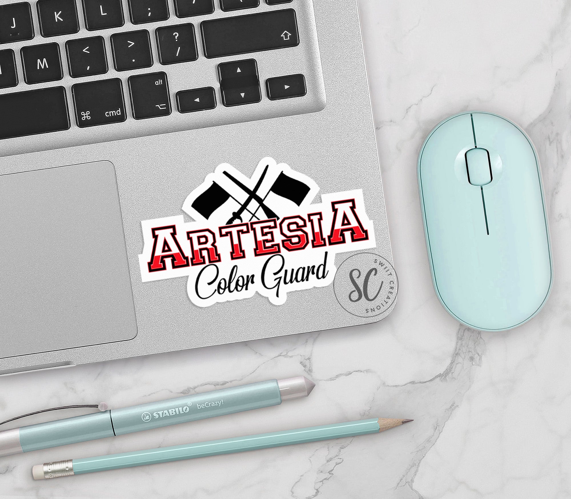 a laptop computer sitting on top of a white table