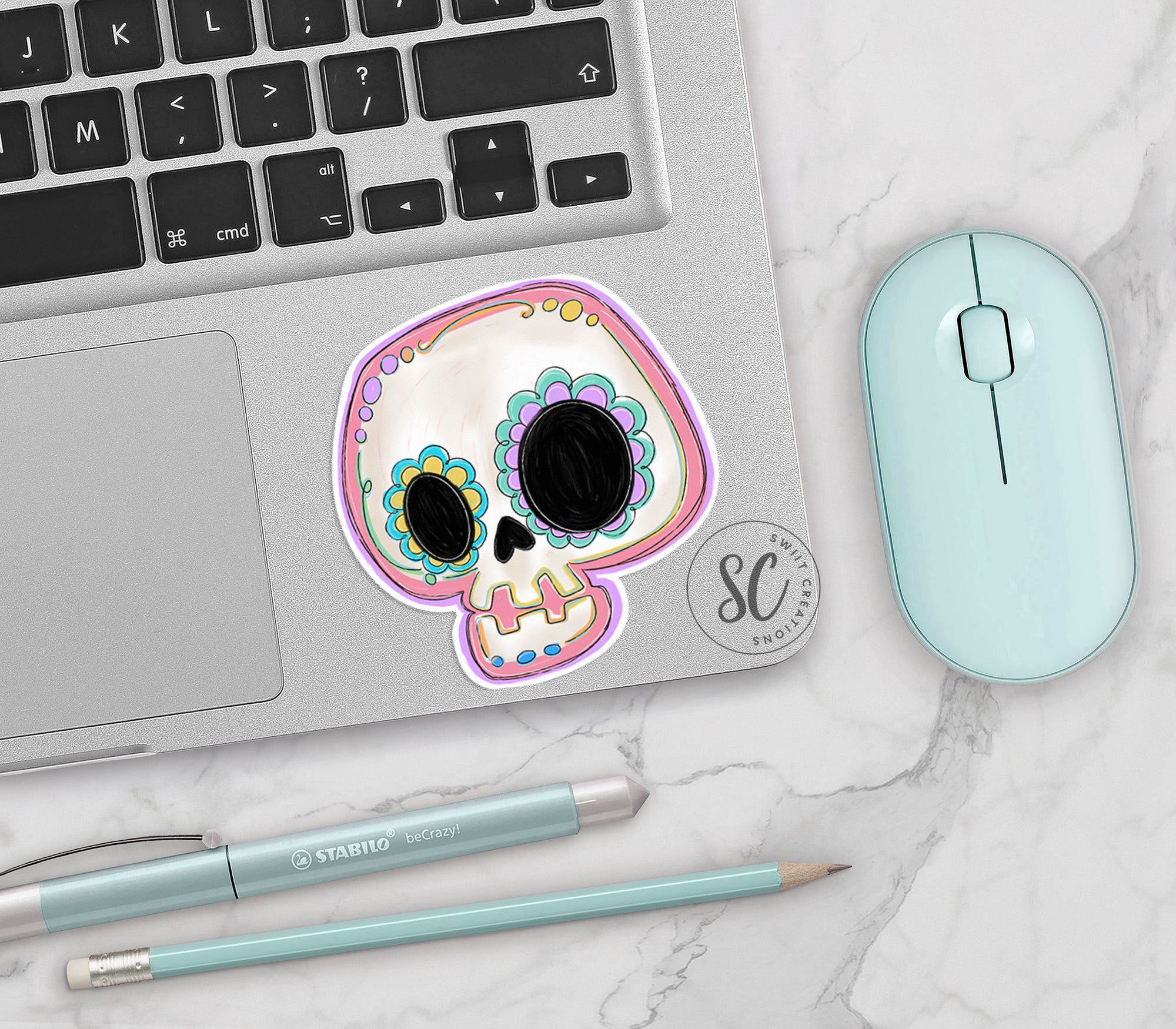 a laptop with a sticker of a skull on it