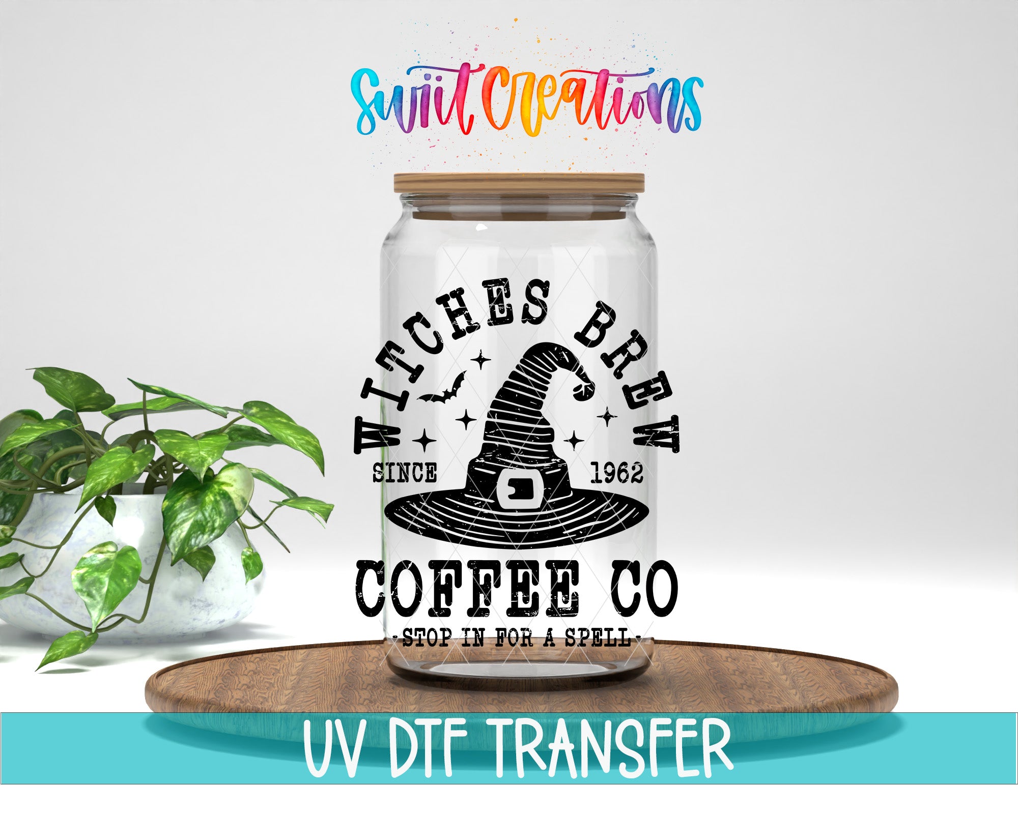 a glass jar with a witch's hat design, placed on a wooden tray. The jar has a label that reads "WITCHES BREW COFFEE COFFEE CO STOP IN FOR A SPELL". Above the jar, there is a colorful text that says "Swit Creations". The jar is placed on a wooden surface, and there is a potted plant in the background.