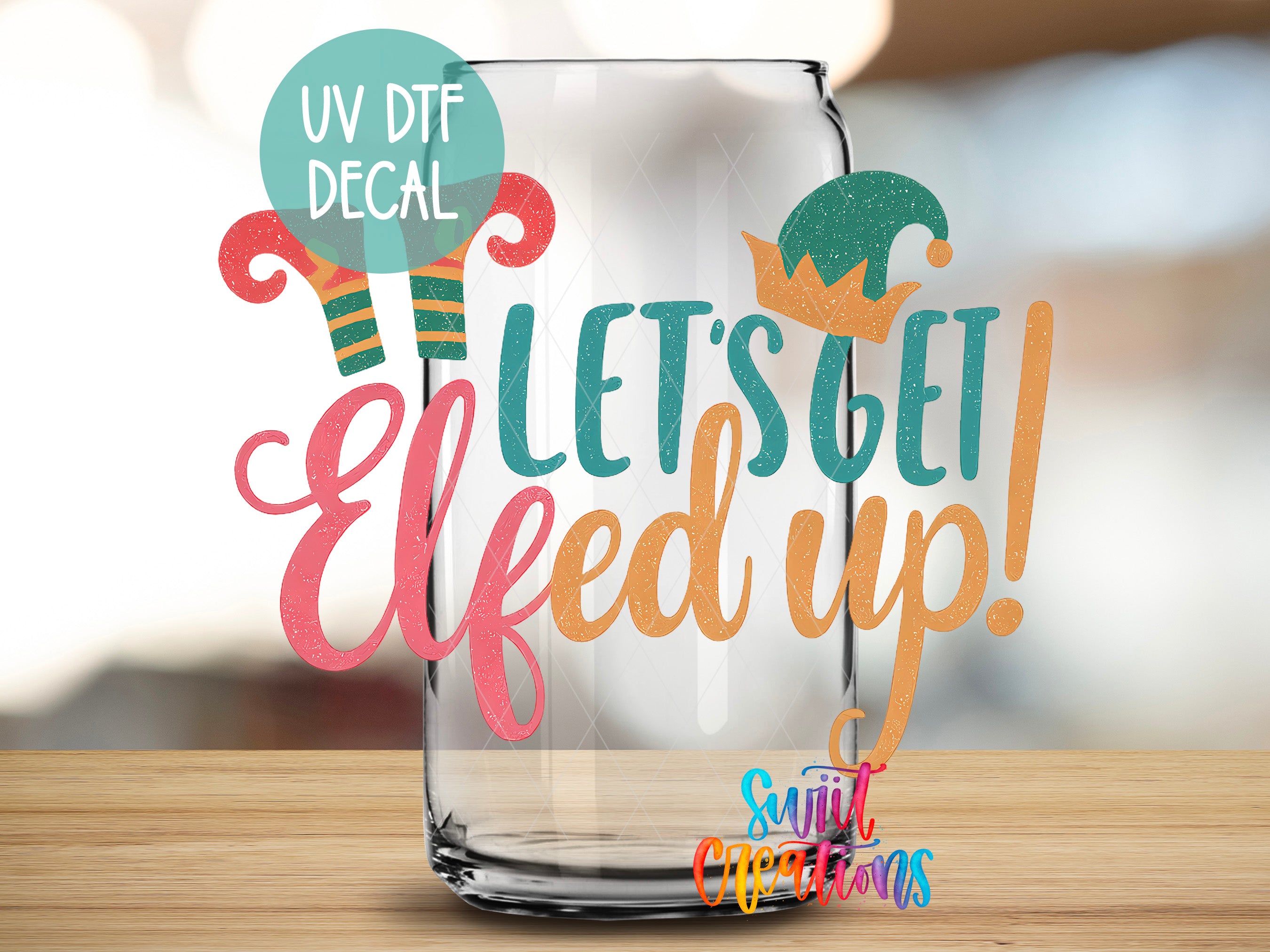 a clear glass jar with a colorful, festive design and text that reads "Let's get Elfed up!"