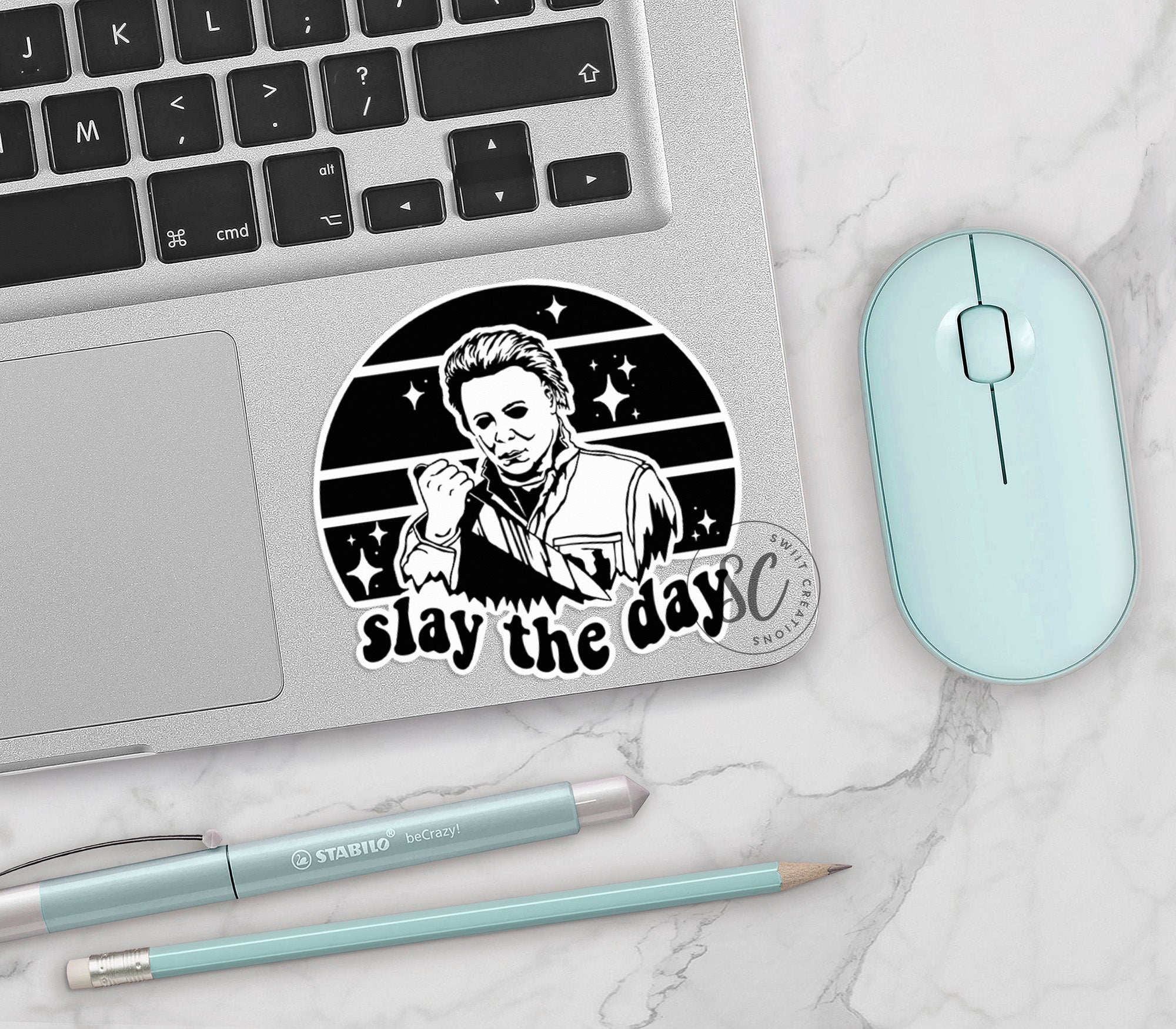 a laptop with a sticker on it next to a mouse