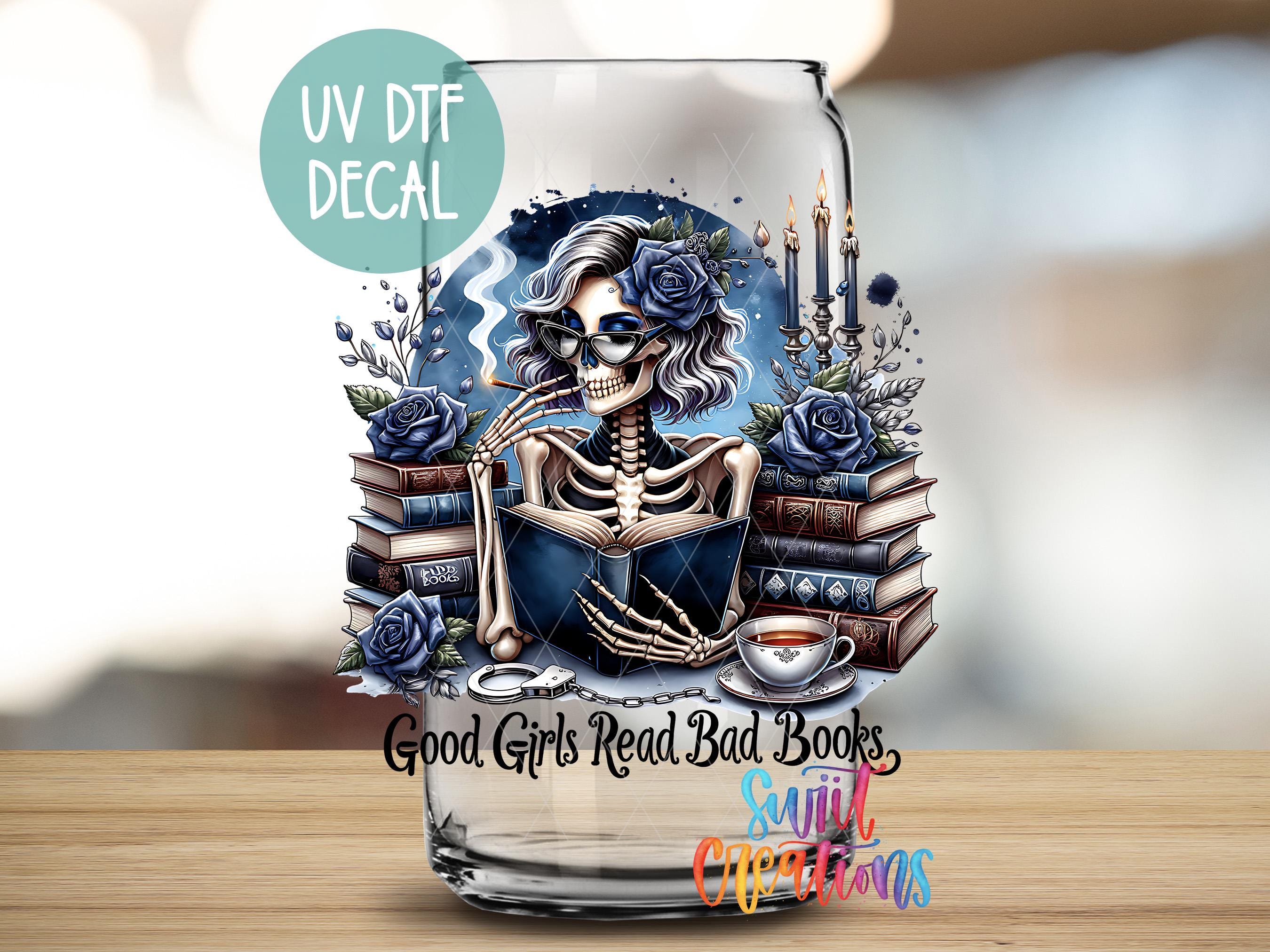 a glass with a picture of a skeleton reading a book