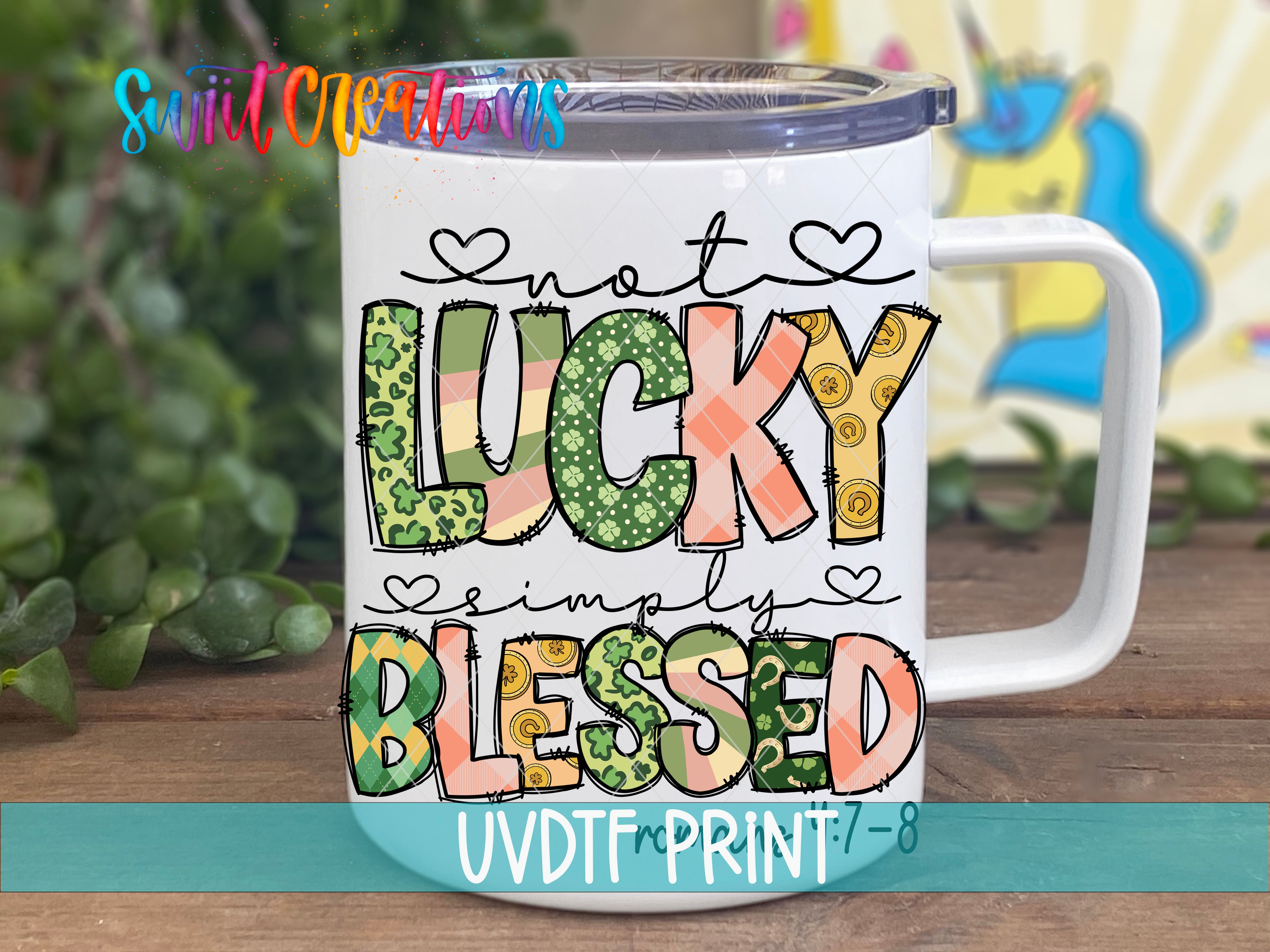 A white mug with colorful text and graphics on it, placed on a wooden surface.