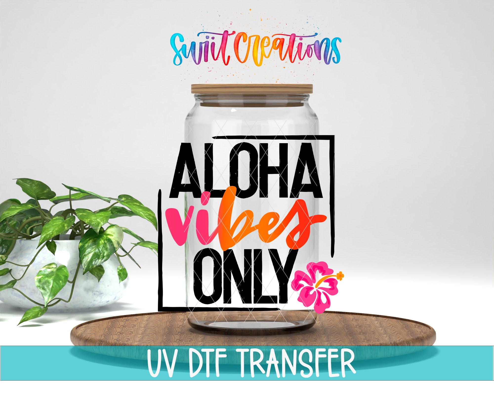 a clear glass jar with a wooden lid, surrounded by a potted plant and a wooden tray. The text on the jar reads "ALOHA VIBES ONLY" and "UV DFT TRANSFER".