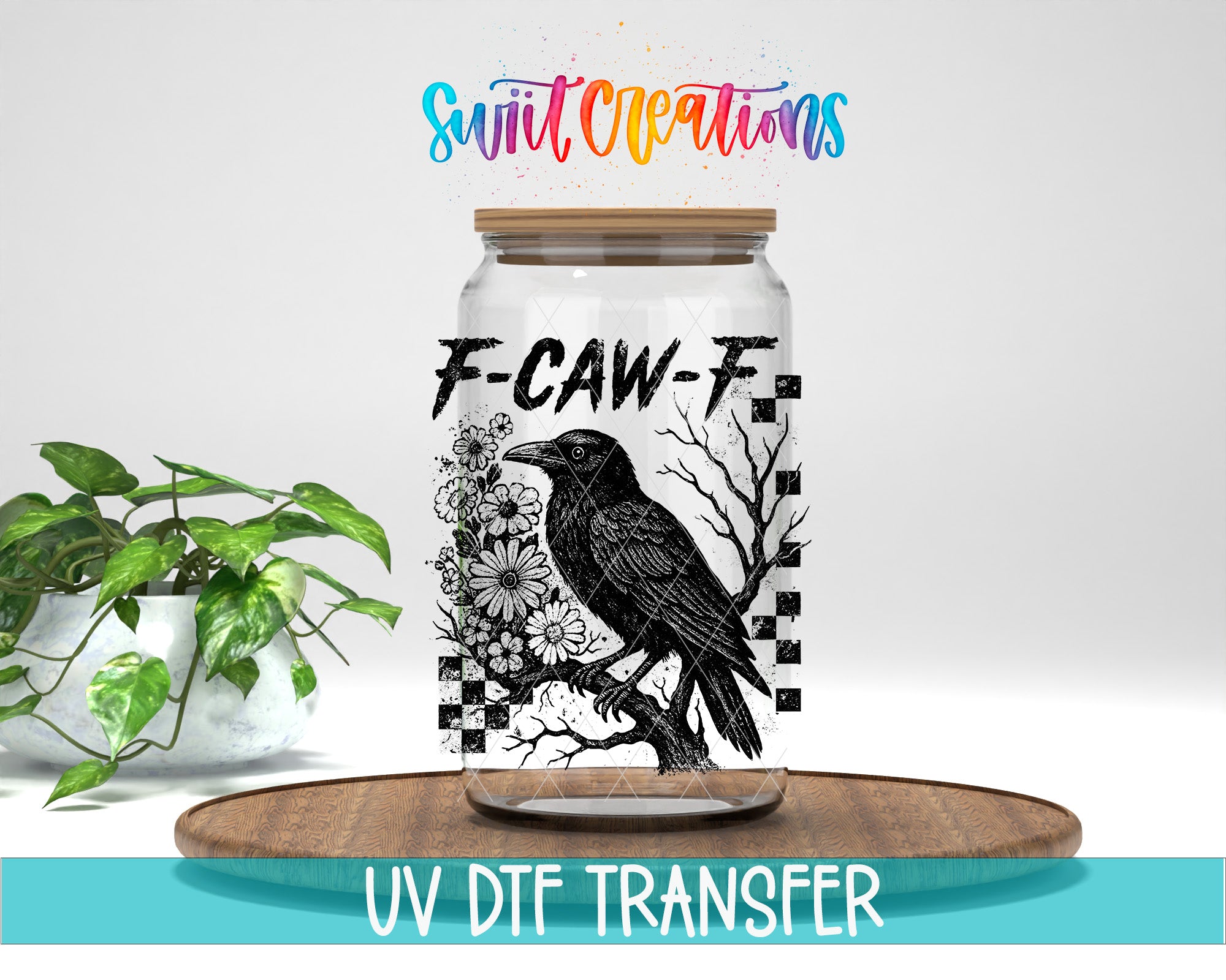 a glass jar with a black bird design on it, placed on a wooden surface. The jar has a label that reads "F-CAW-F". There is also a plant in the background.