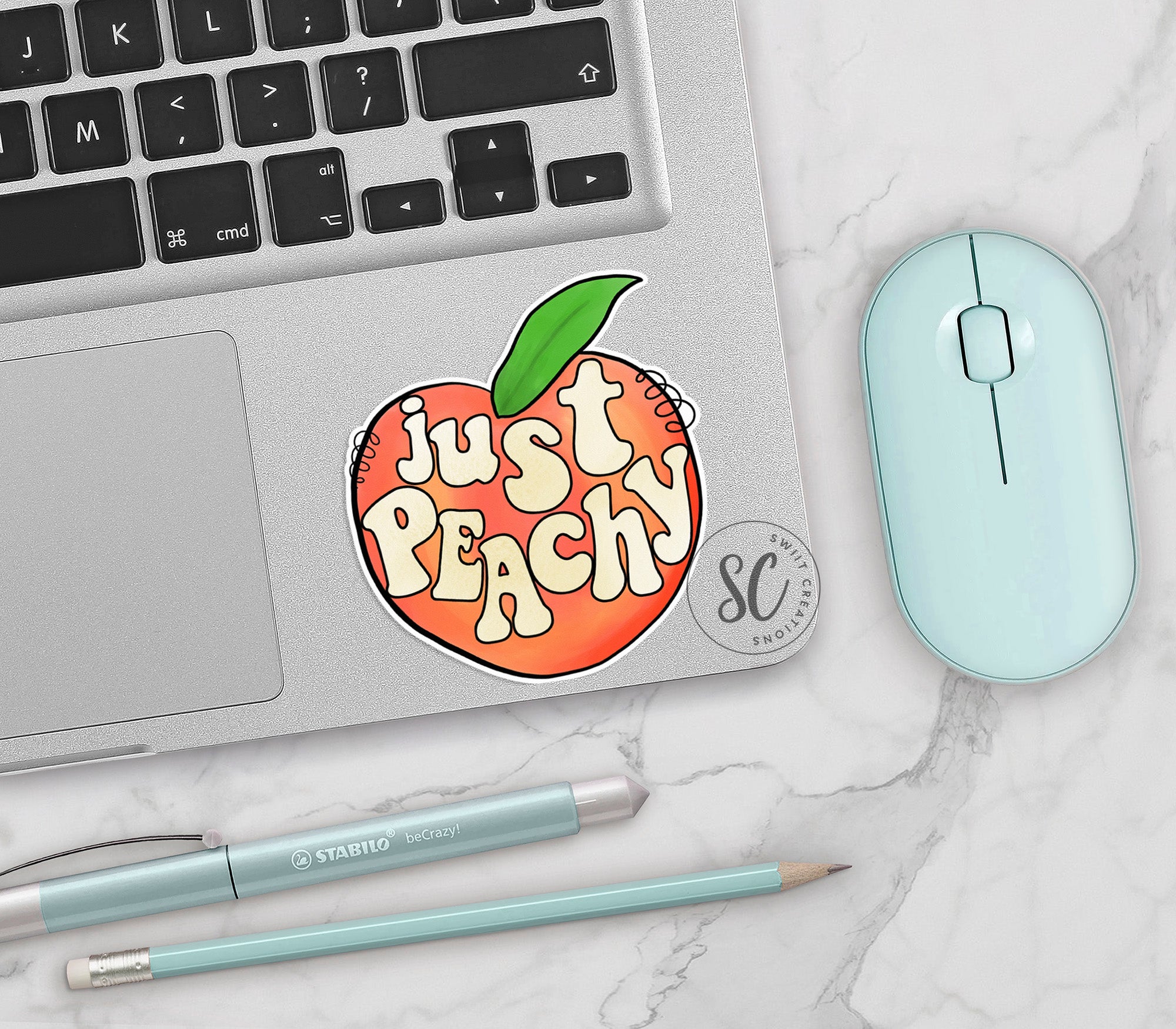 a laptop with a sticker of a peach on it