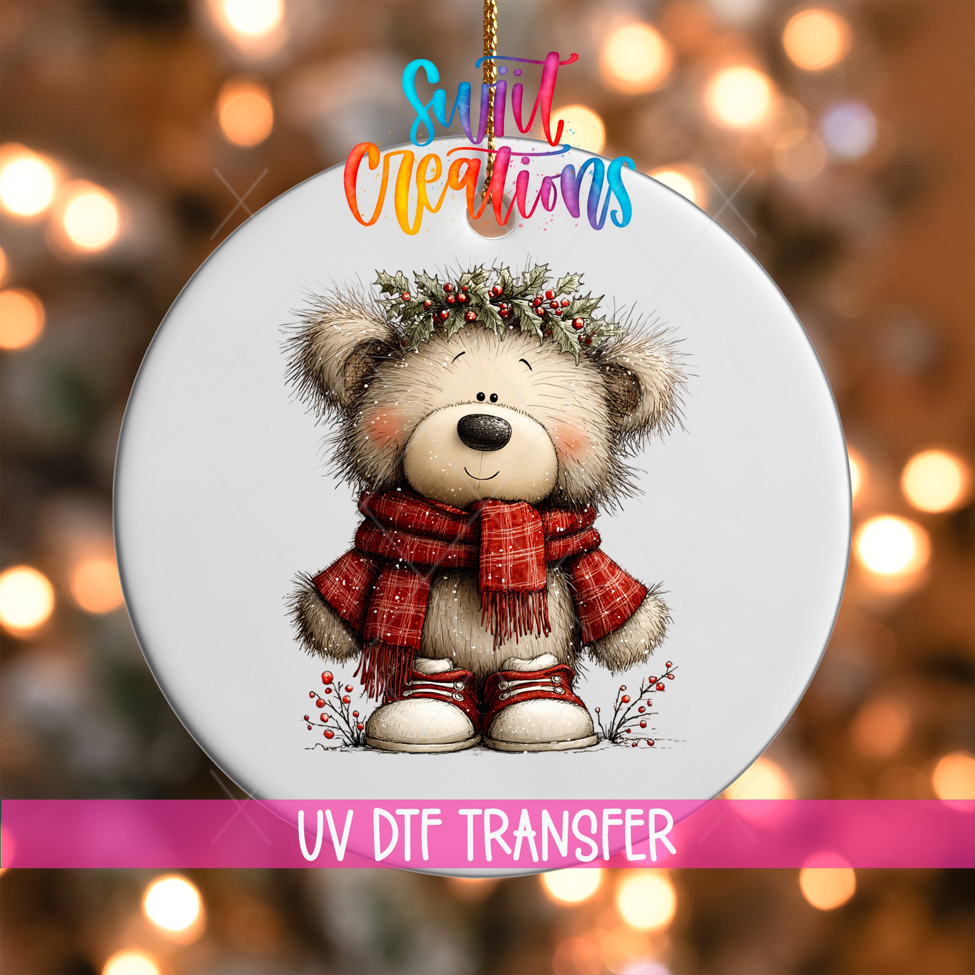 A white ornament with a teddy bear wearing a red scarf and a holly wreath on its head, set against a blurred background with colorful lights.