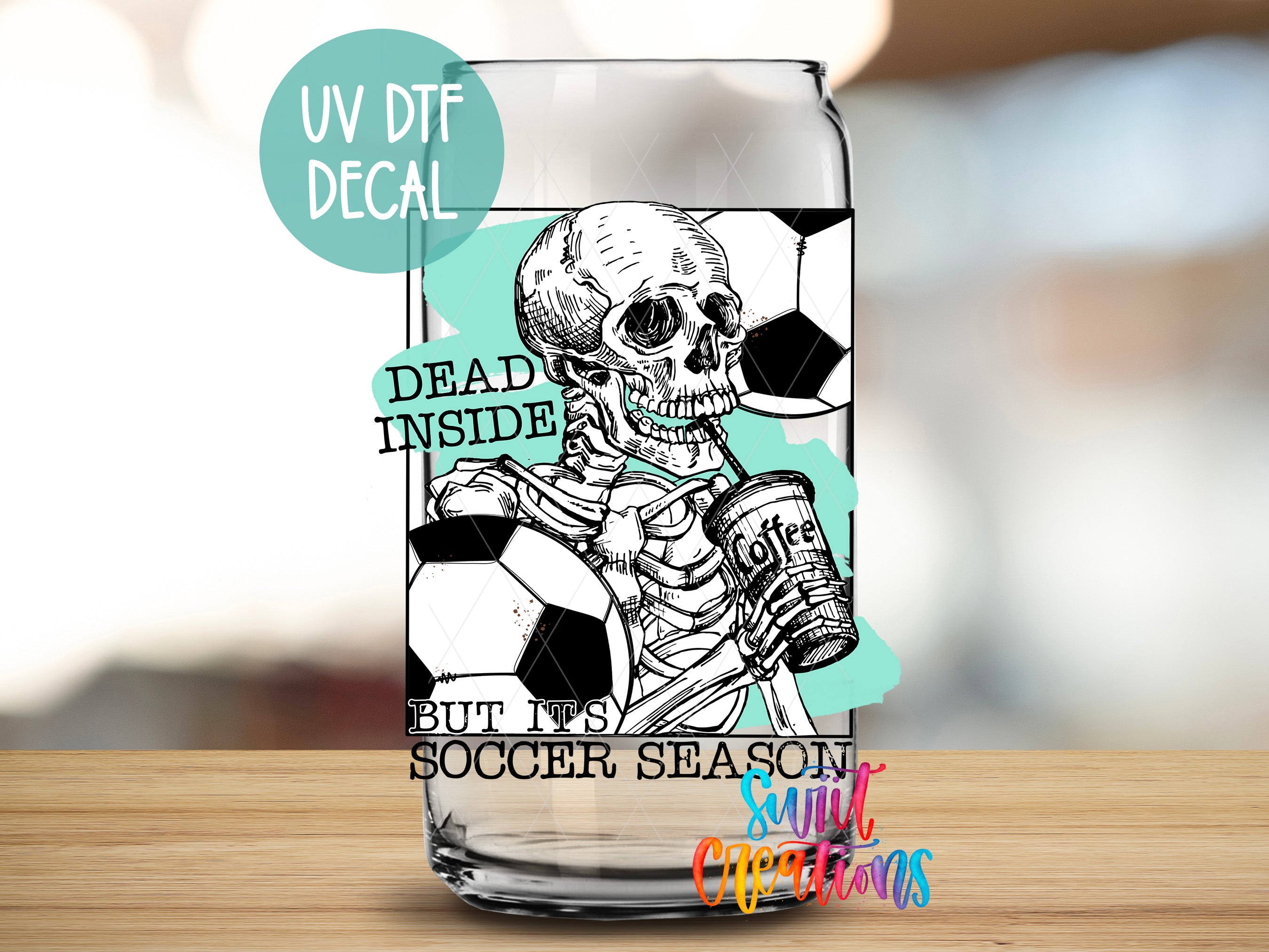 a glass with a skeleton holding a soccer ball