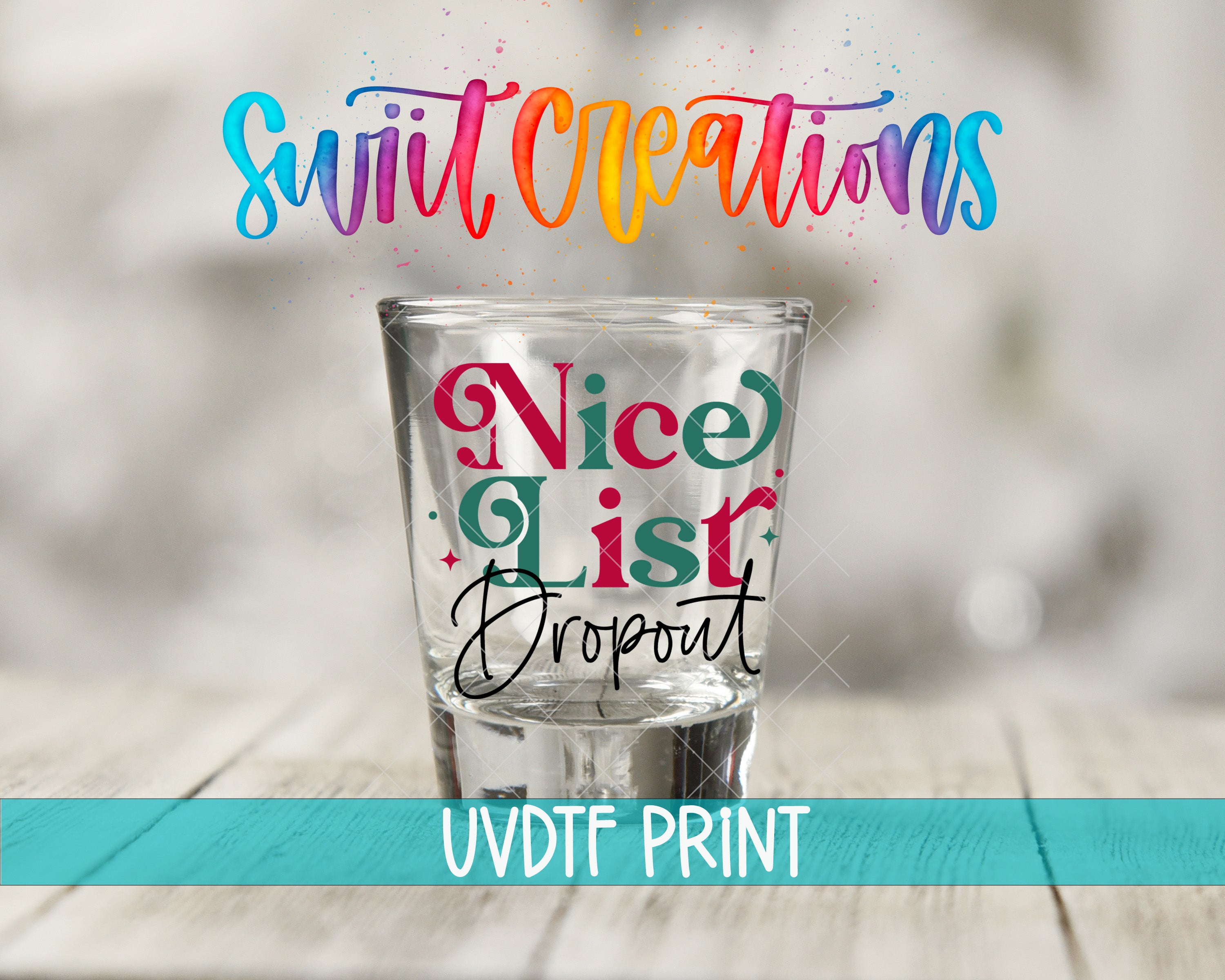 a shot glass with colorful text on it, placed on a wooden surface.