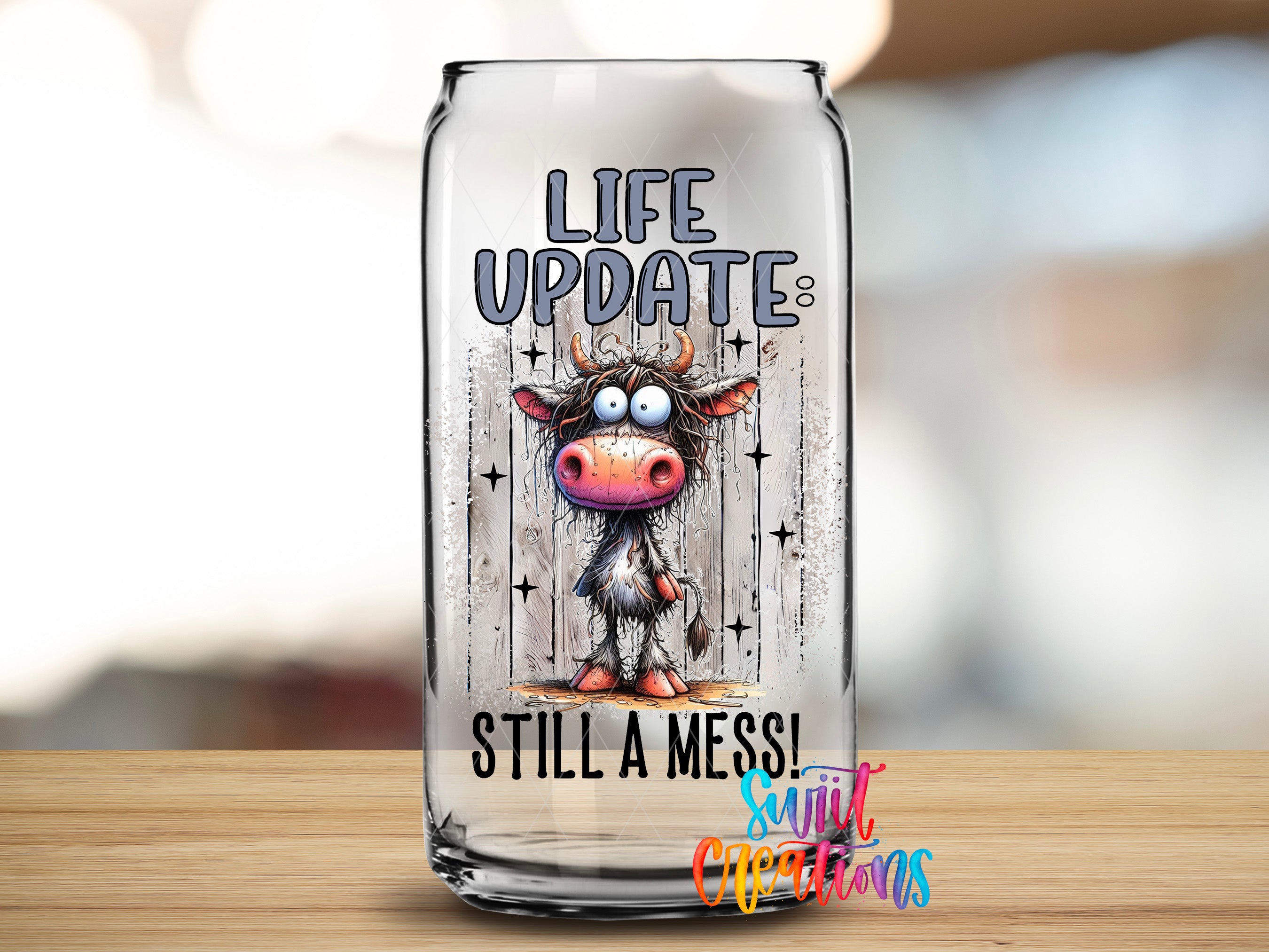 a glass can with a cartoon cow and the text "LIFE UPDATES STILL A MESS!"