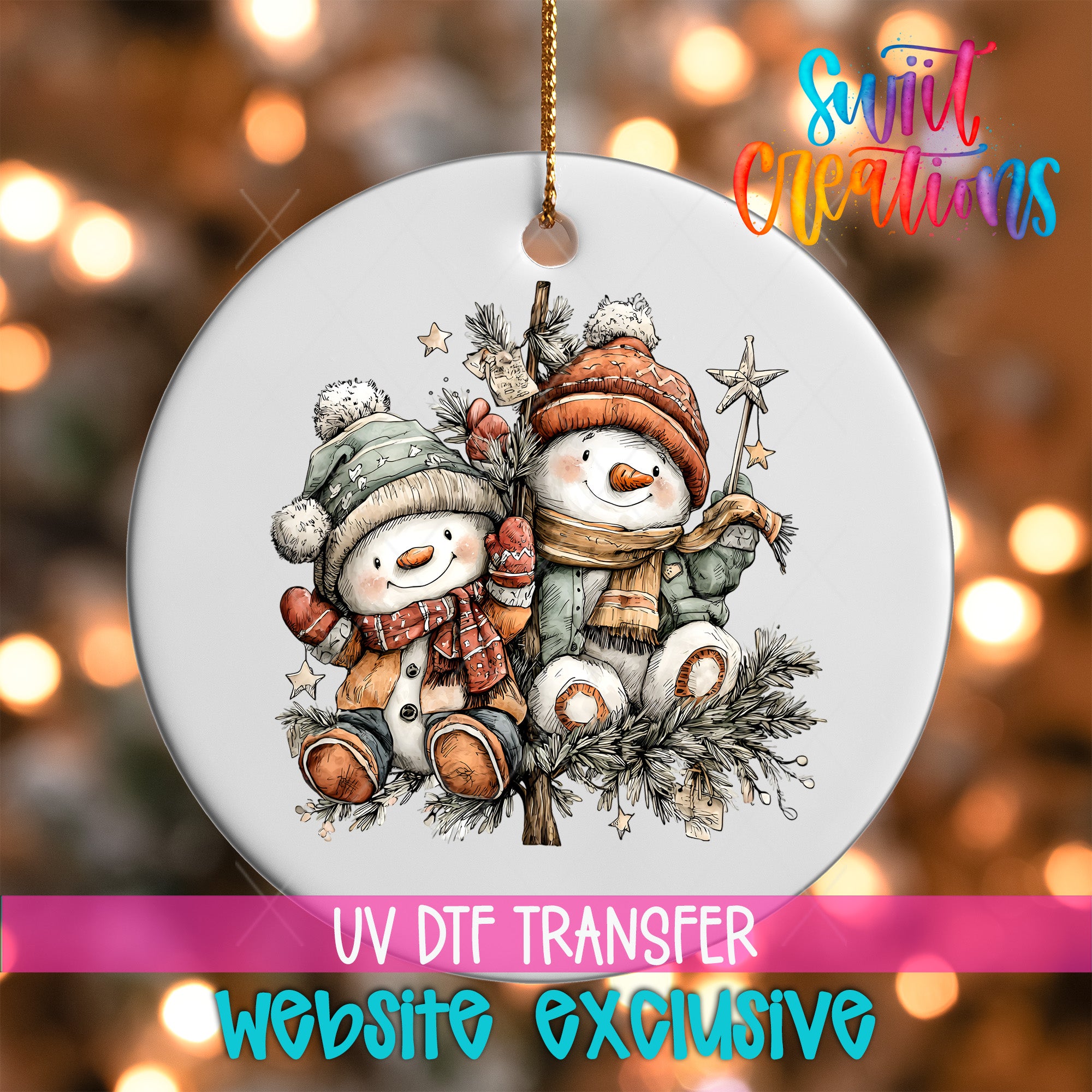 A white ornament with a snowman and star on a branch, surrounded by pine branches and other holiday decorations, with a pink banner below that reads "UV DFT Transfer Website exclusive".