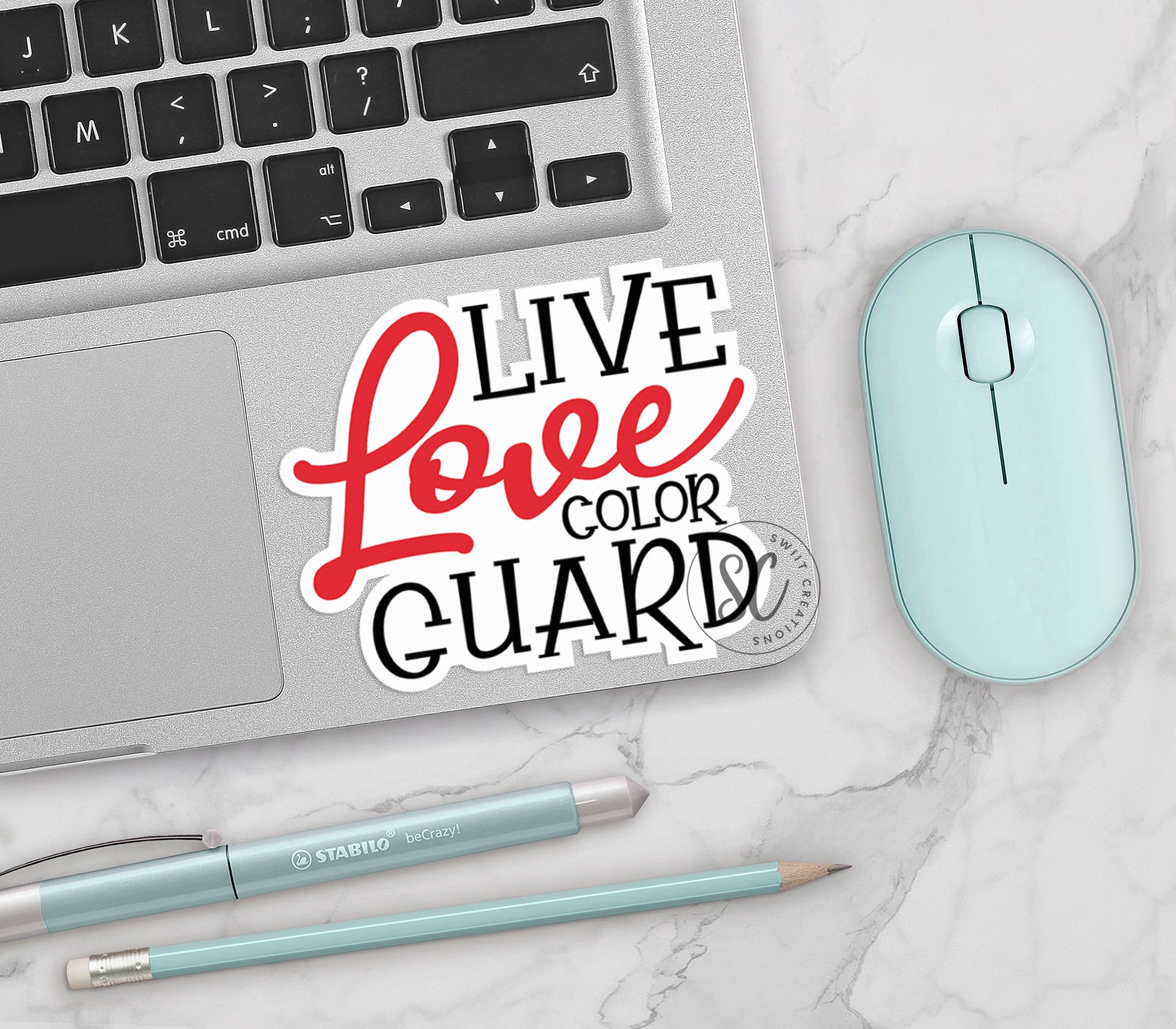 a laptop with a sticker that says live love color guard next to a mouse