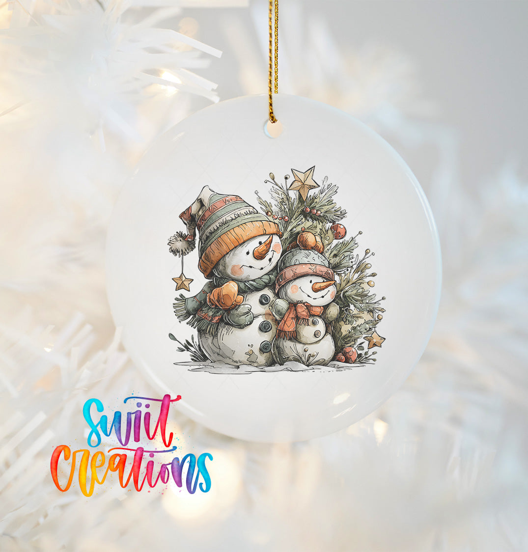 A white ceramic ornament featuring two snowmen, one larger and one smaller, sitting together under a Christmas tree.