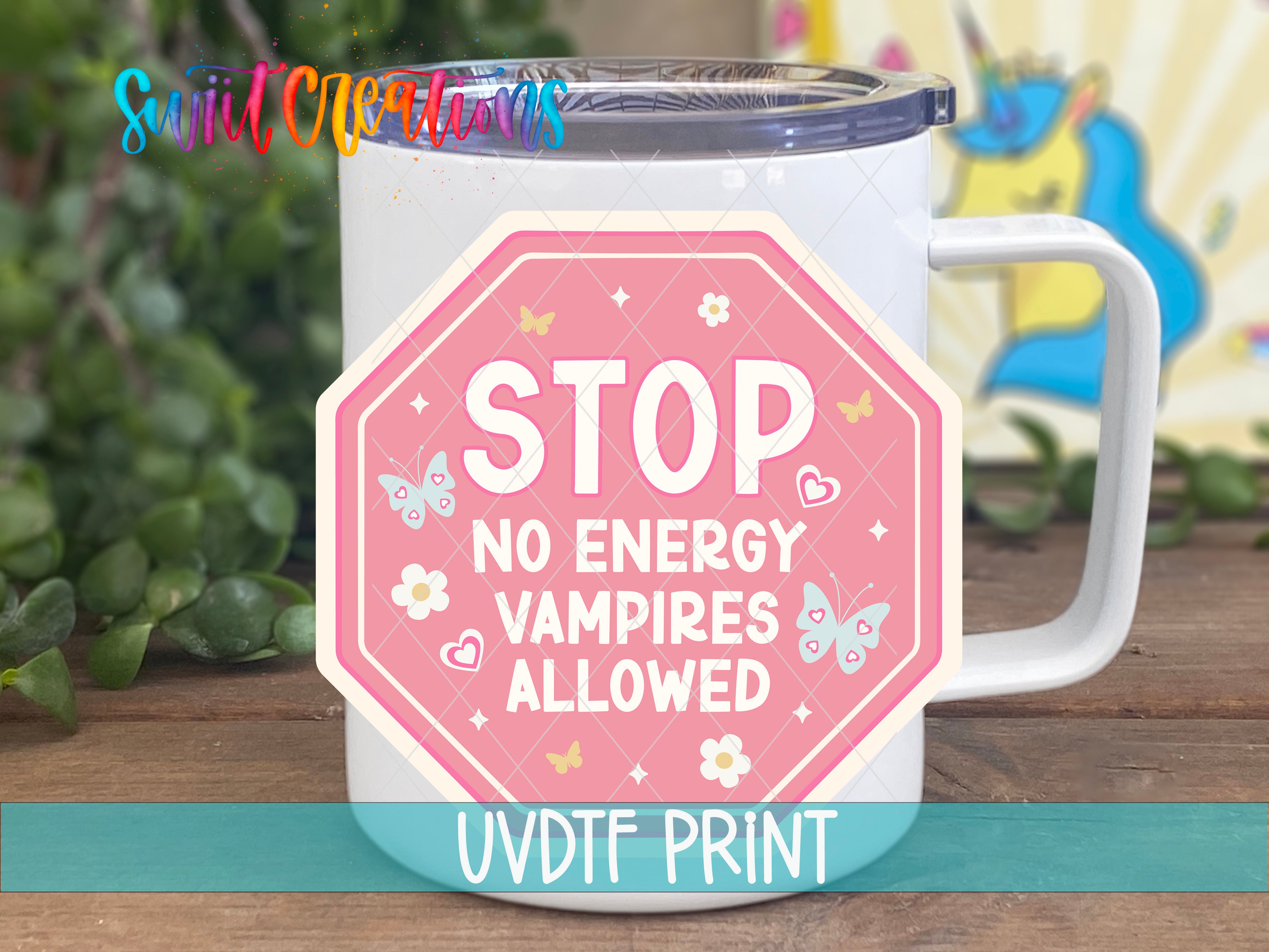 A white mug with a pink and white sticker that says "STOP NO ENERGY VAMPIRE ALLOWED" and features butterflies and flowers.