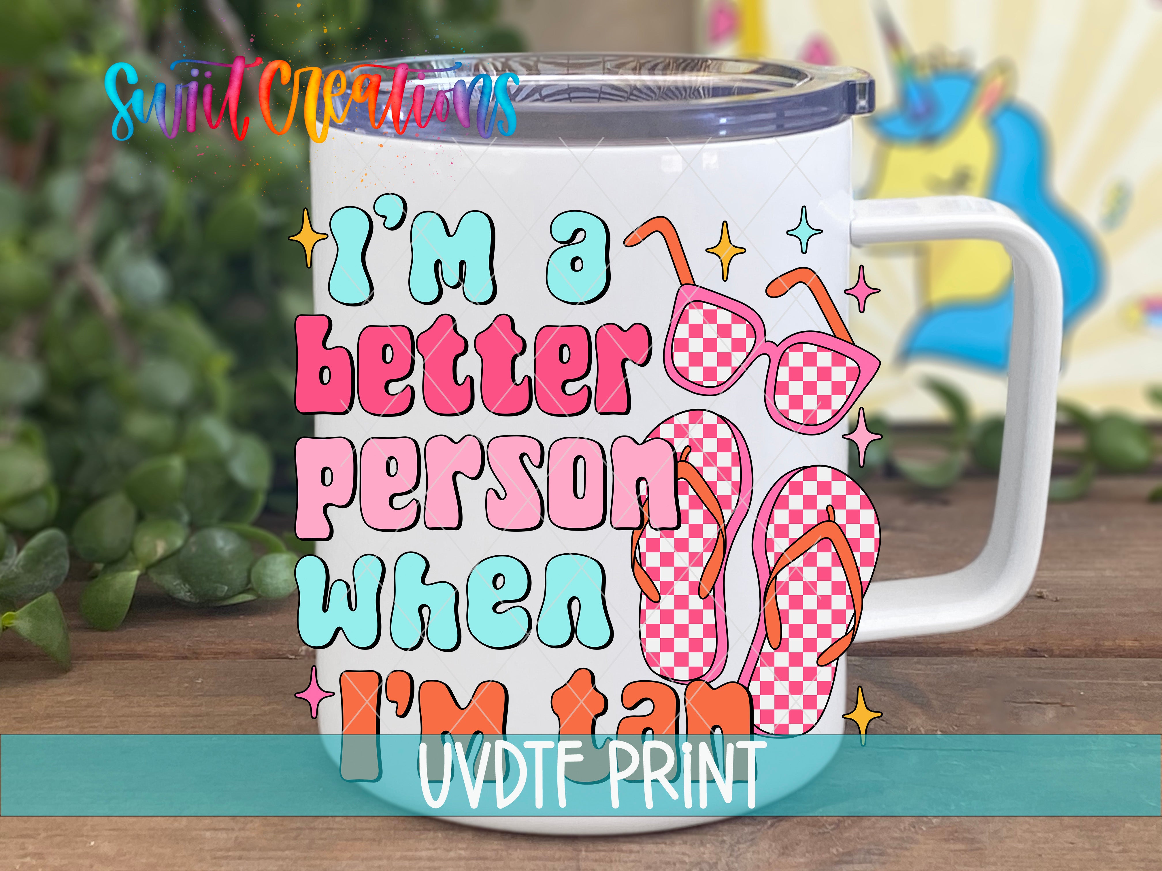 A white mug with a colorful design featuring sunglasses, flip flops, and text that says "I'm a better person when I'm tan".