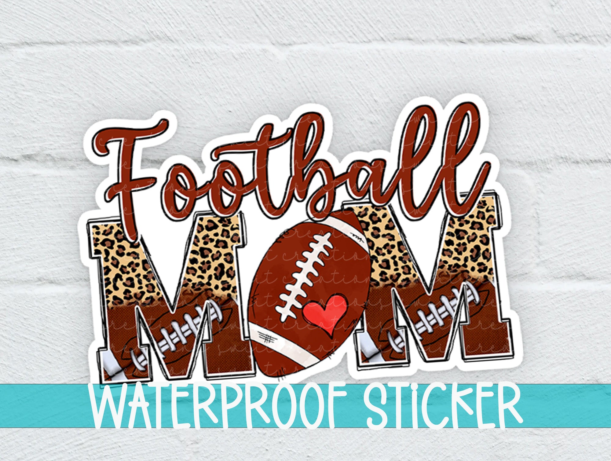 a football mom sticker on a white brick wall