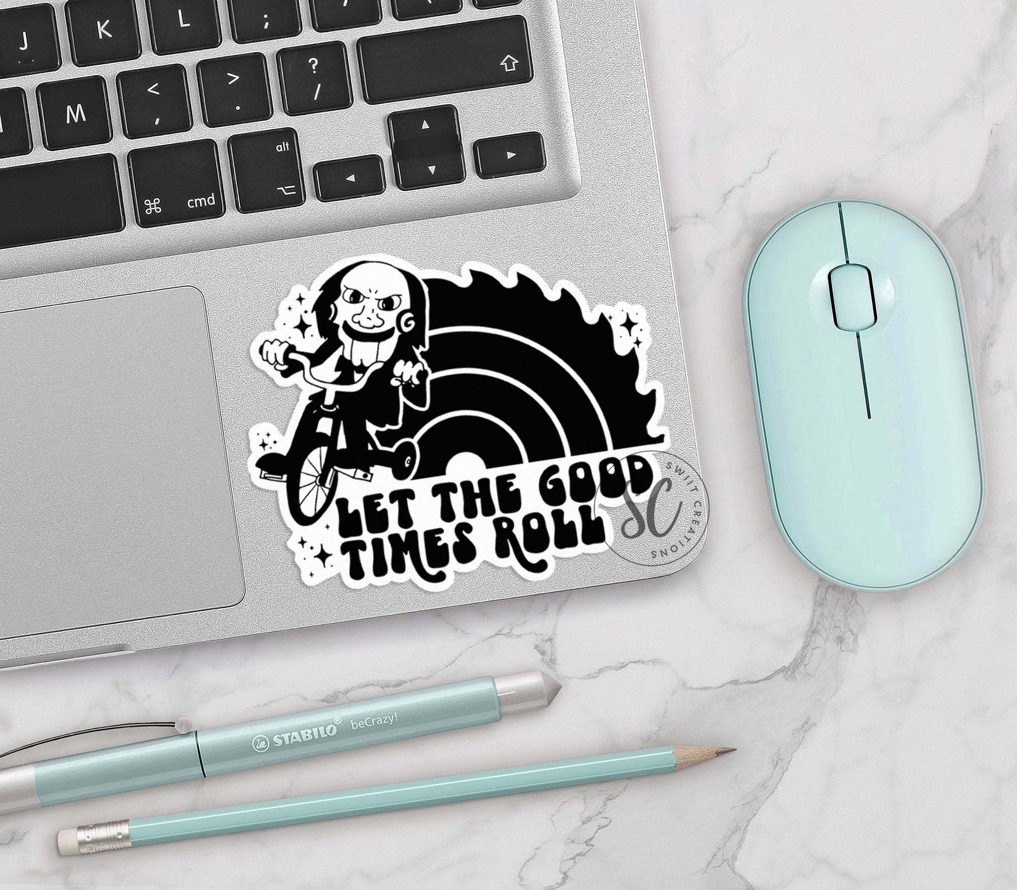 a laptop with a sticker of a girl riding a bike