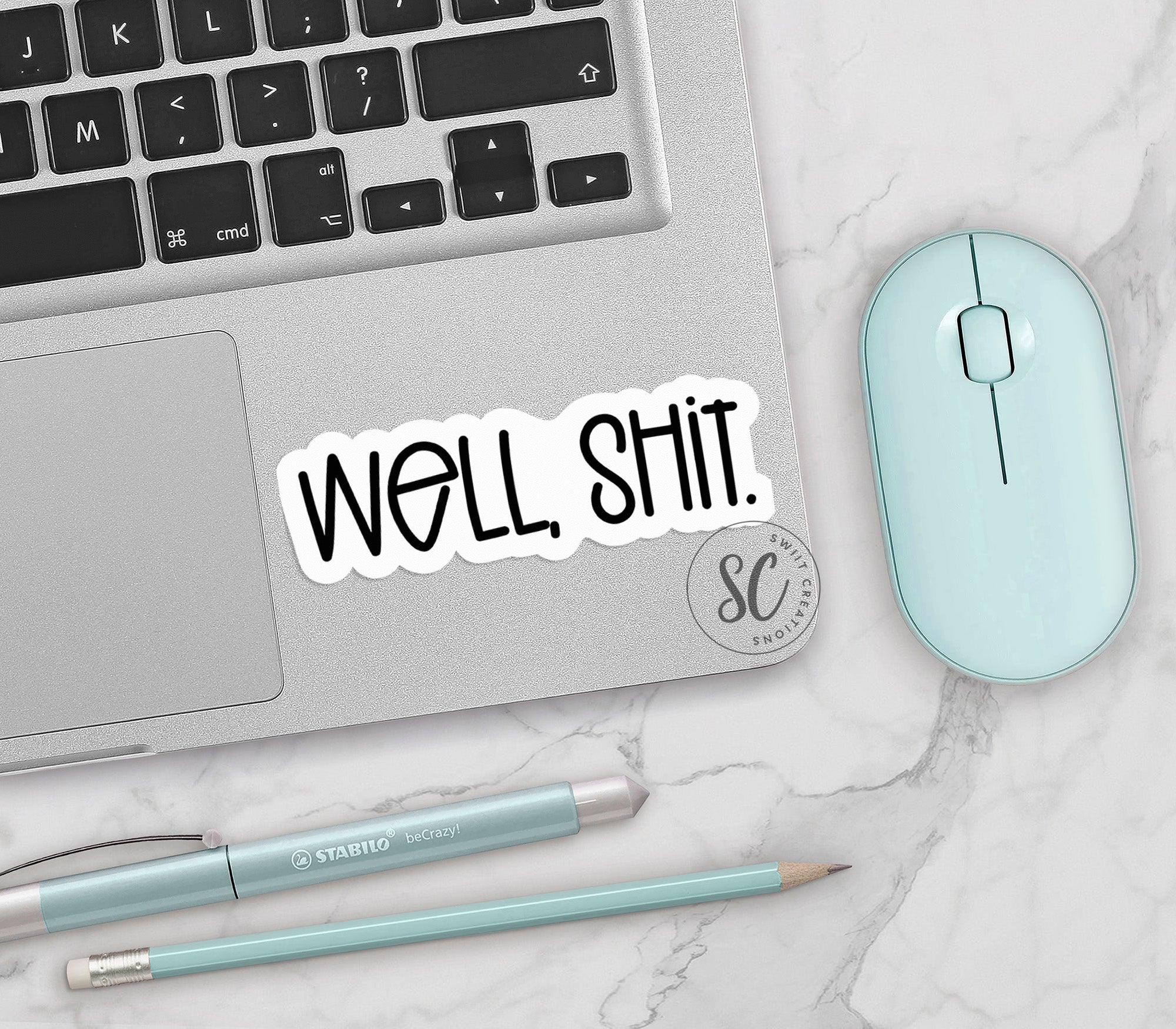 a laptop with a sticker that says, well shit