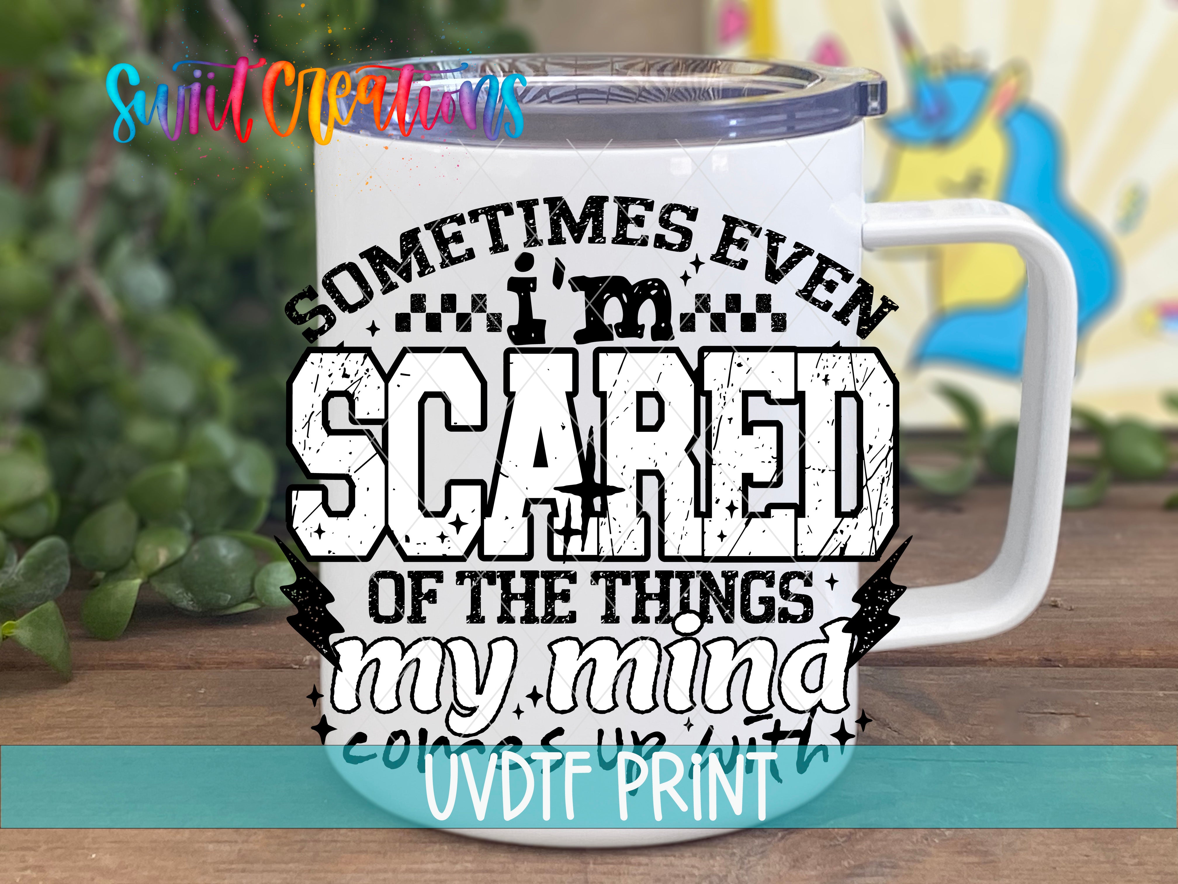 A white mug with a printed design on it, featuring the text "Sometimes even scared of the things my mind does up with" along with a graphic of a person.