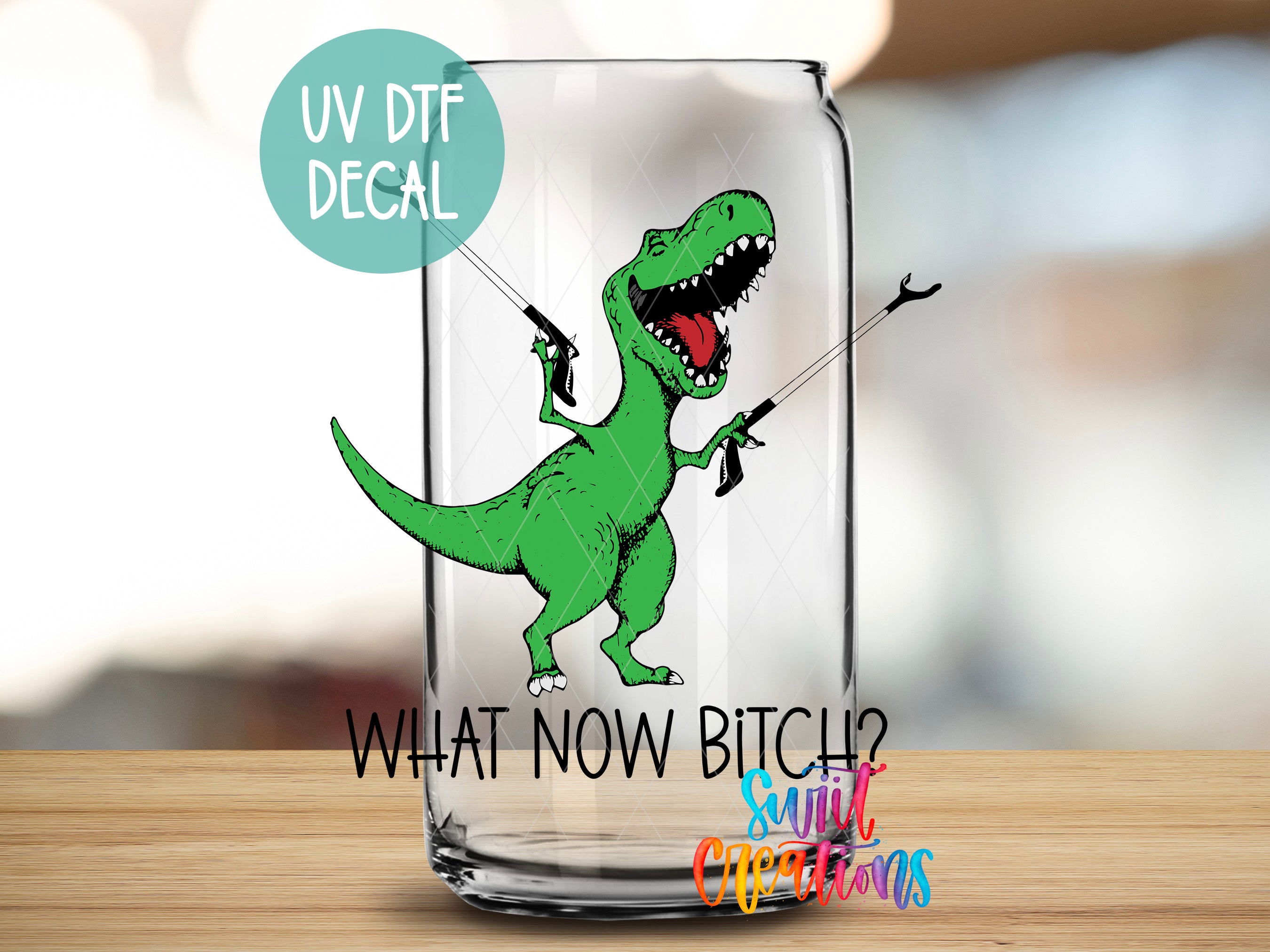 a glass with a picture of a dinosaur holding a kite