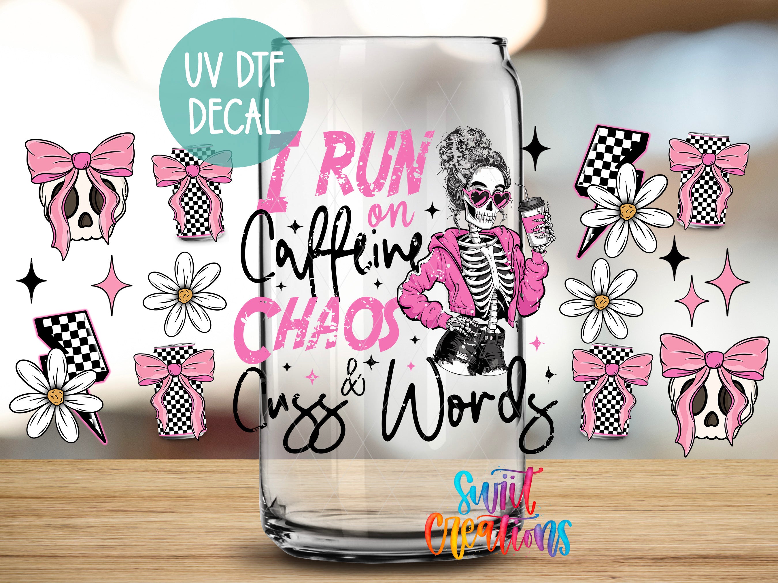 a glass with a design that includes a skeleton wearing sunglasses and holding a coffee cup, surrounded by various pink and white floral and bow designs.