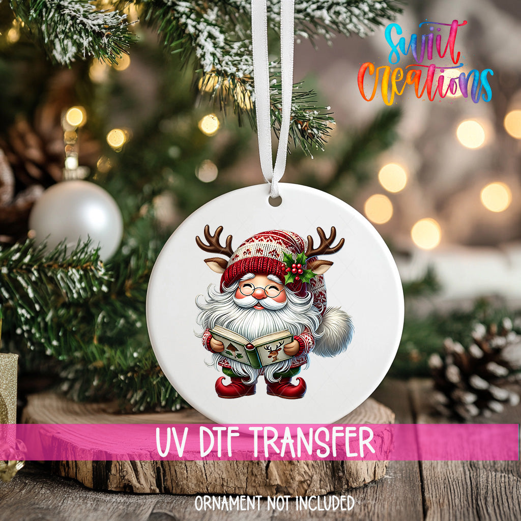 A white ornament with a Santa Claus image hanging on a Christmas tree.