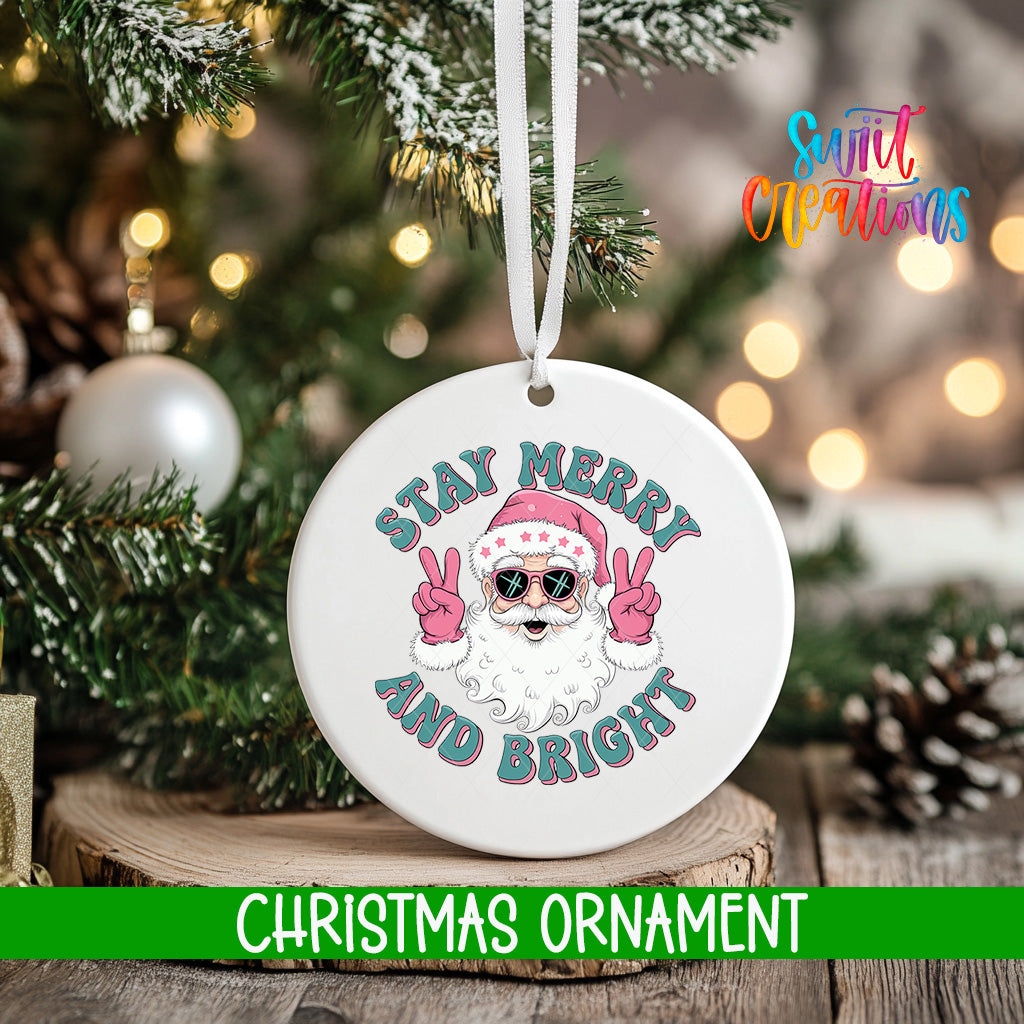 A white Christmas ornament with a Santa Claus face and the text "STAY MERRY AND BRIGHT" is hanging on a tree.