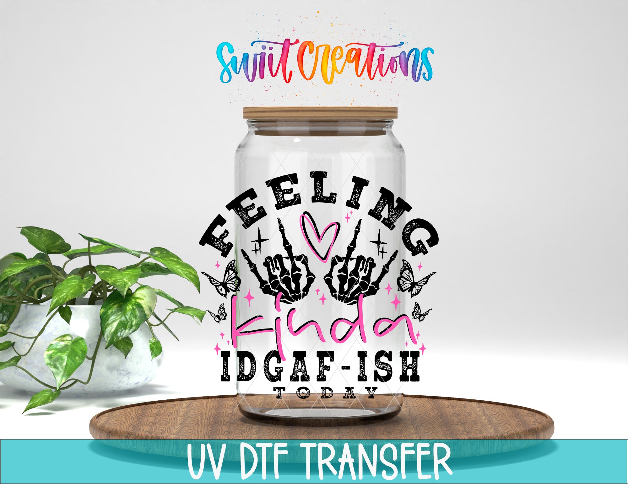 a glass jar with a hand-drawn design and text on it, placed on a wooden surface.