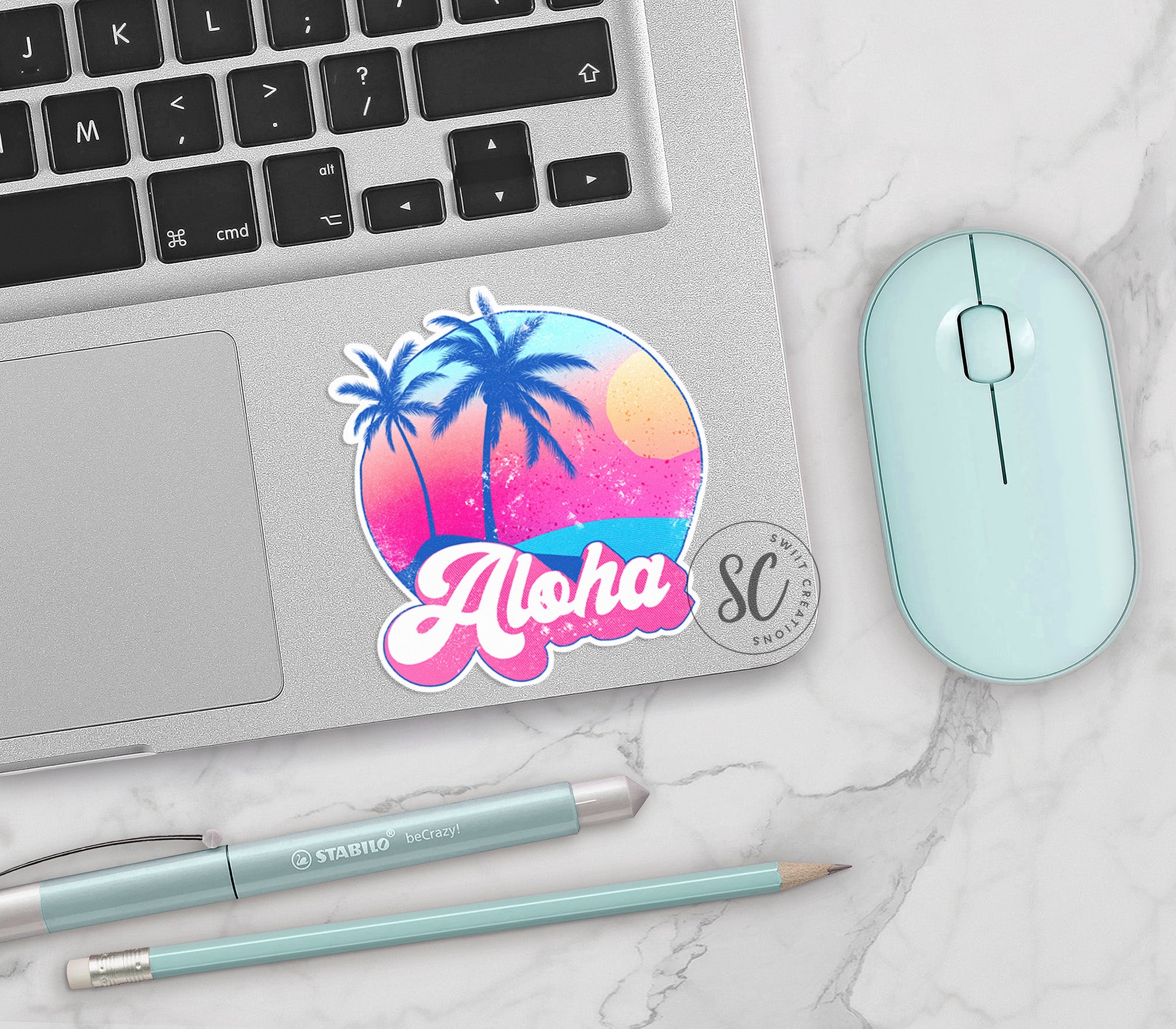 a laptop with a sticker of a palm tree and the word aloha