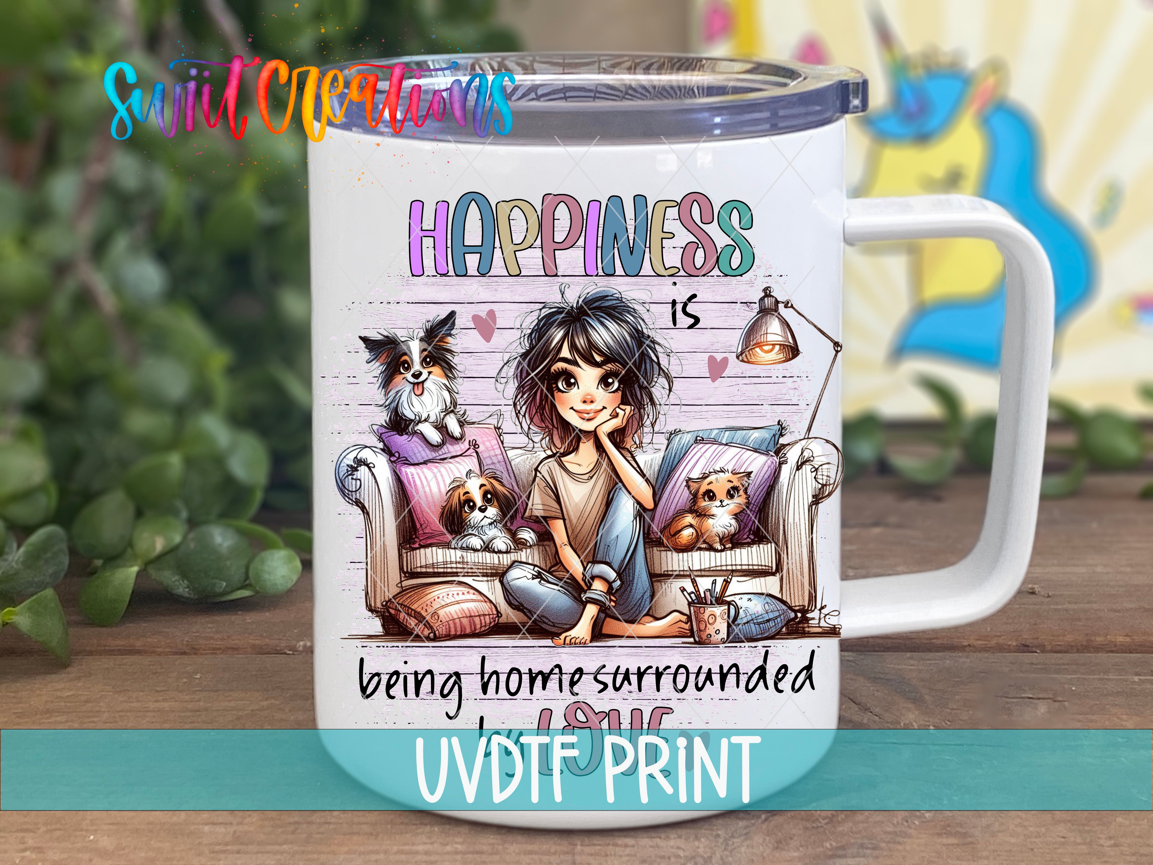 A white mug with a colorful illustration of a woman sitting on a couch with dogs and cats, accompanied by the text "Happiness is being home surrounded by love" and "UVDFRINT".