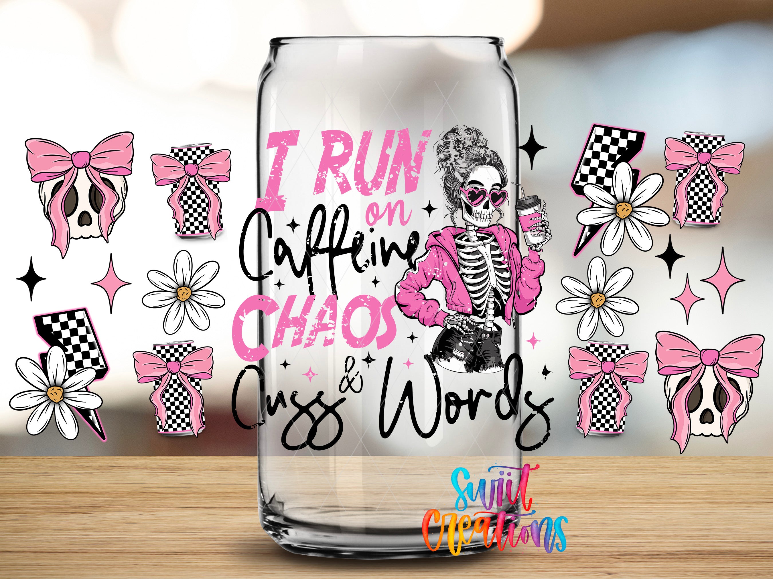 a glass with a design that includes a skeleton wearing sunglasses and holding a coffee cup, surrounded by various pink and white floral and checkered designs.