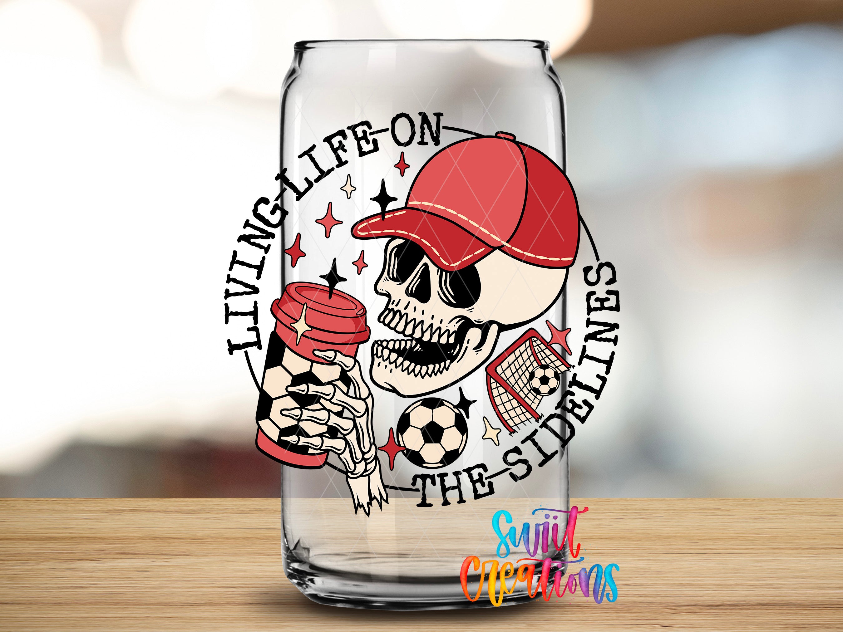 A glass can with a skull wearing a red cap and holding a red cup, surrounded by soccer balls and a soccer net, with the text "LIVING LIFE ON THE SIDEEN" and "THE SIDEEN" written around the image.
