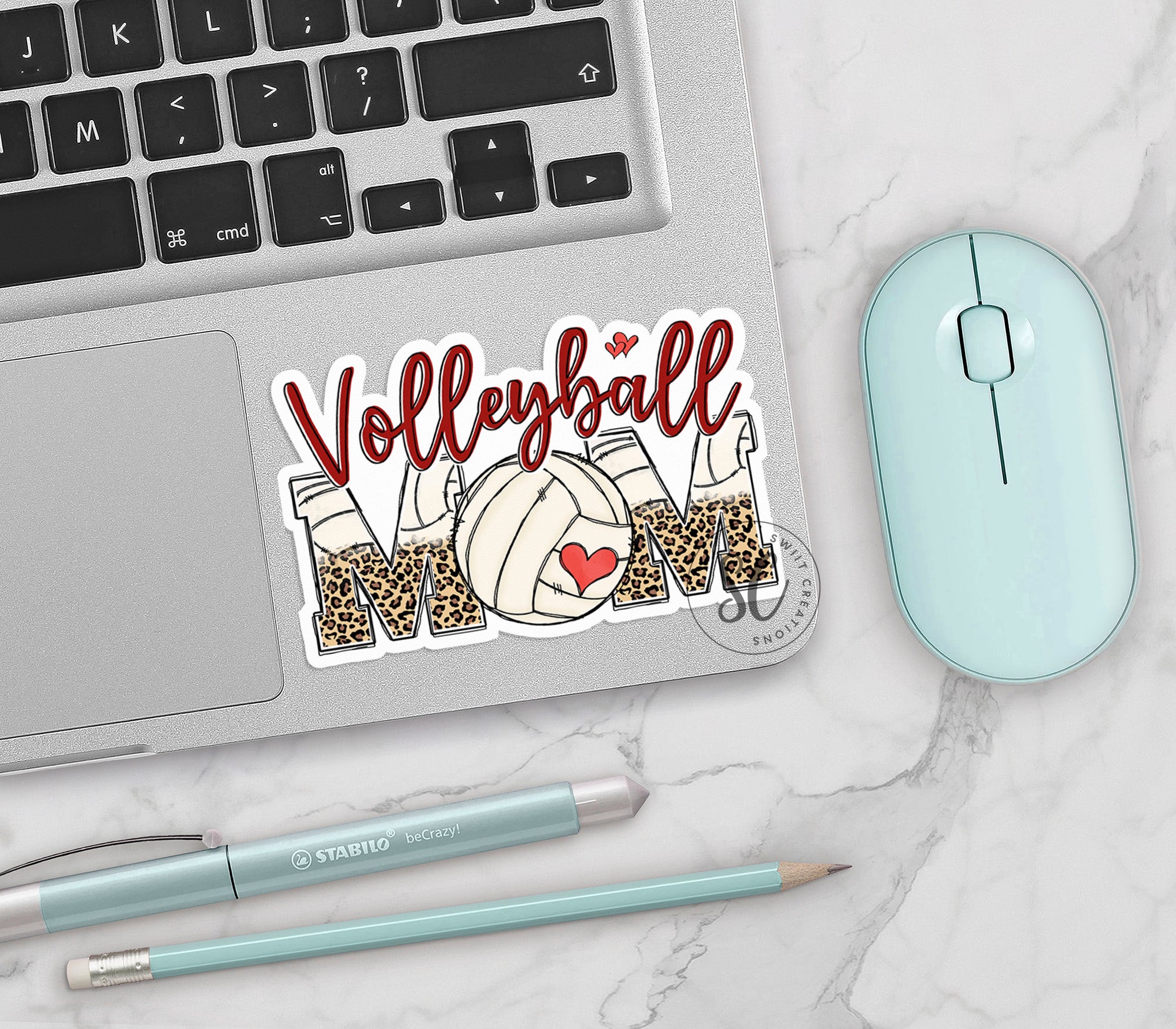 a laptop with a volleyball sticker on it