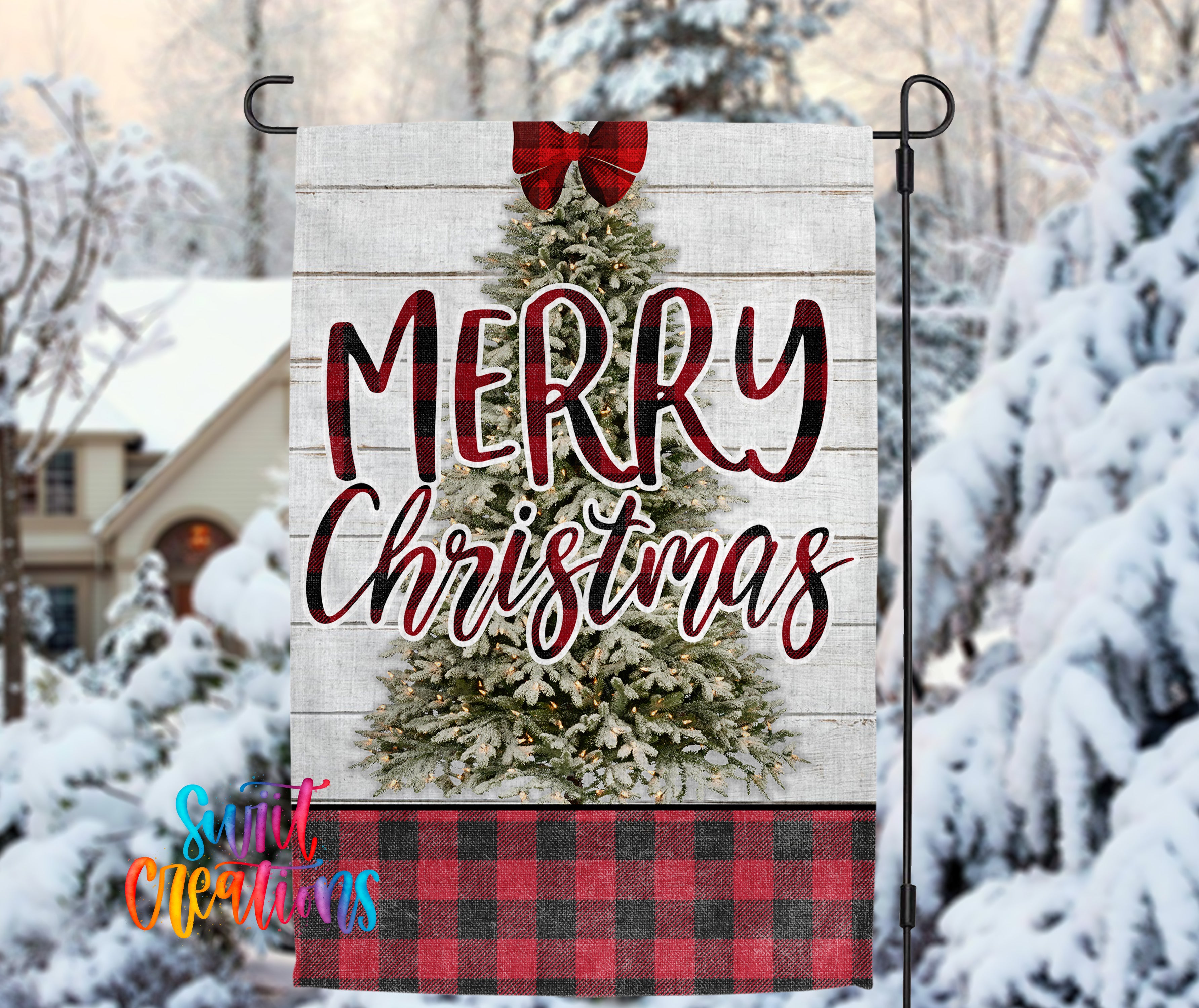 A white wooden Christmas tree with a red bow, surrounded by snow-covered trees, with the text "MERRY CHRISTMAS" displayed on the tree.