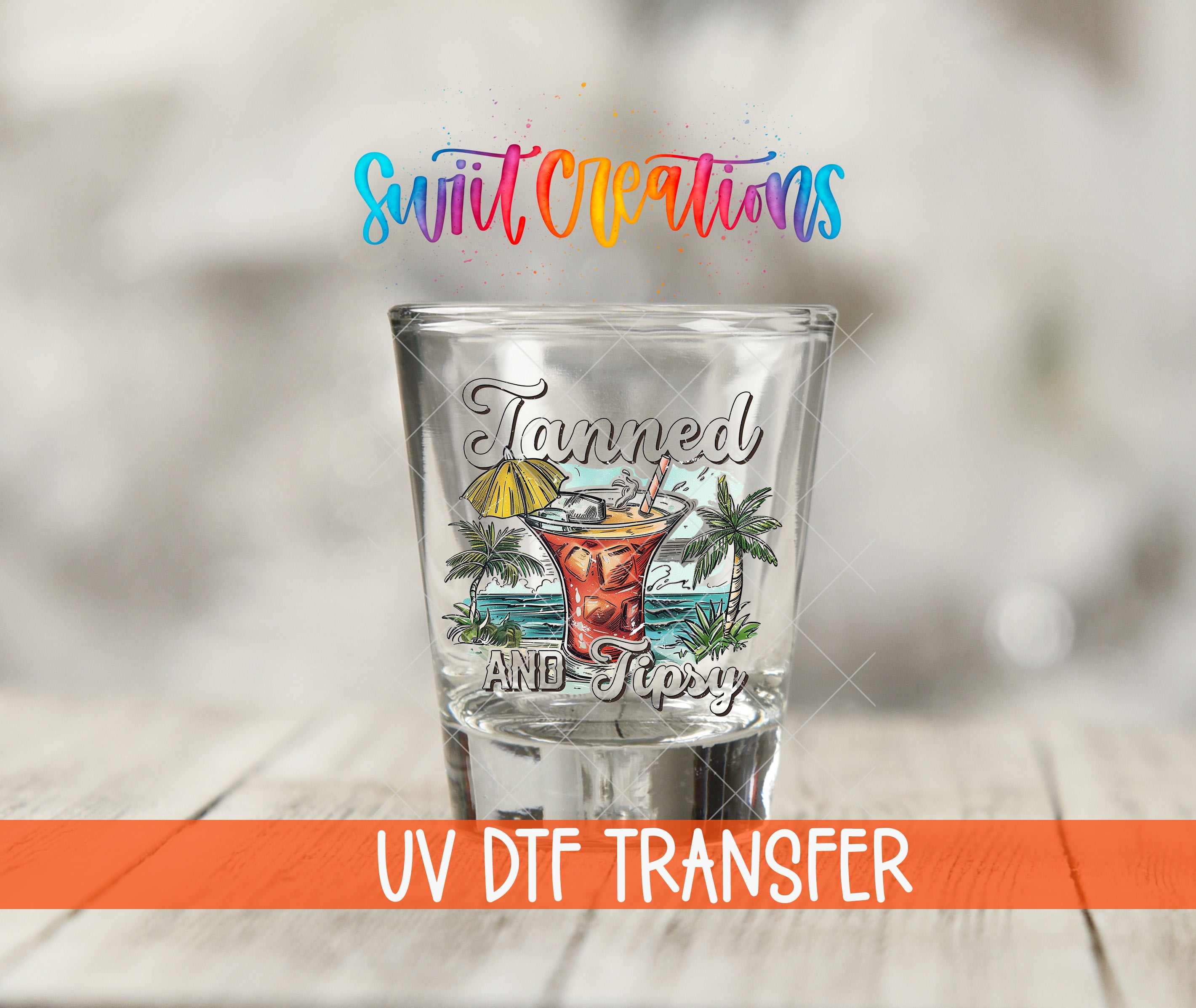A shot glass with a colorful design and text, placed on a wooden surface.