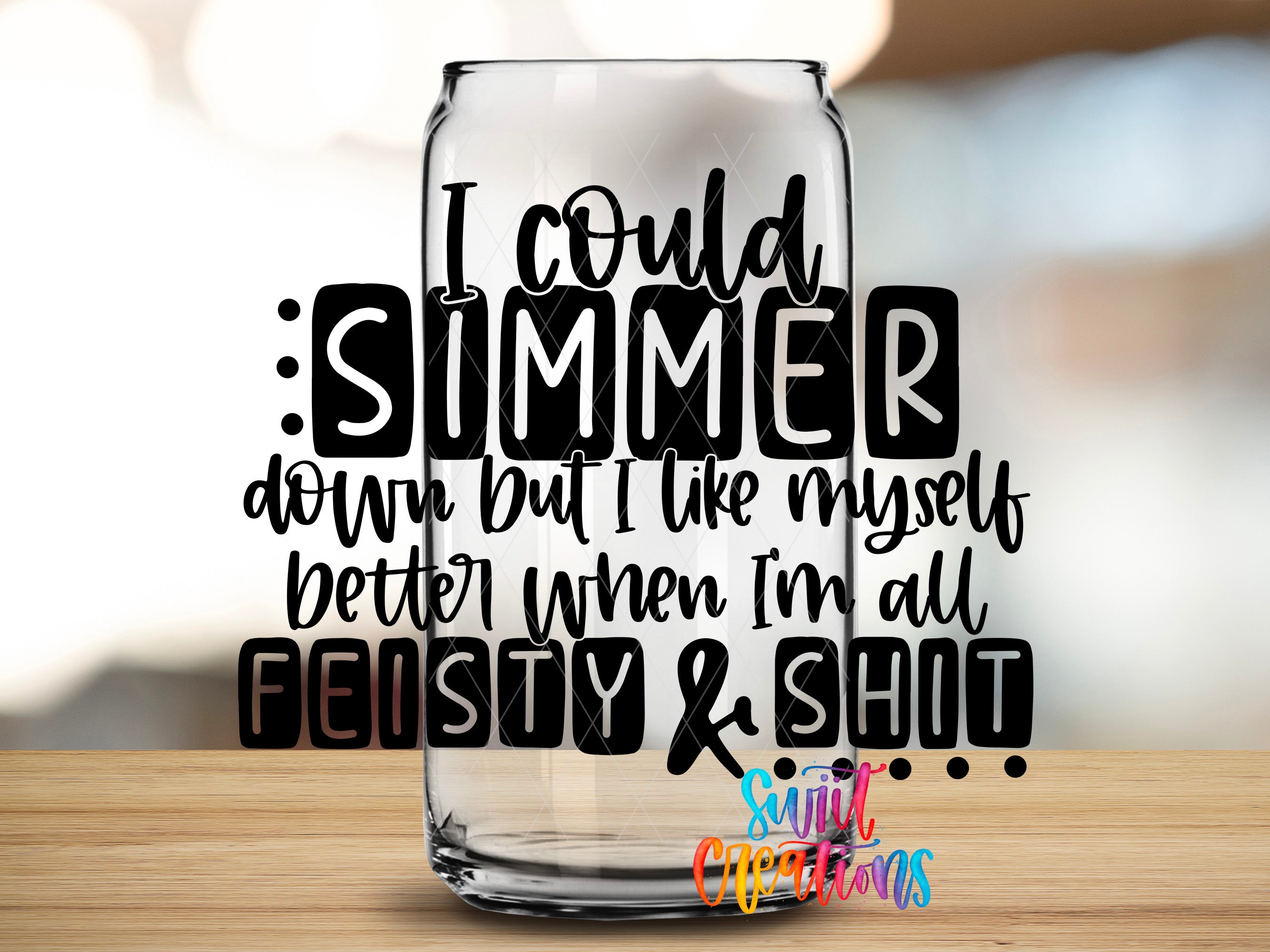 a glass can with text on it, placed on a wooden surface.