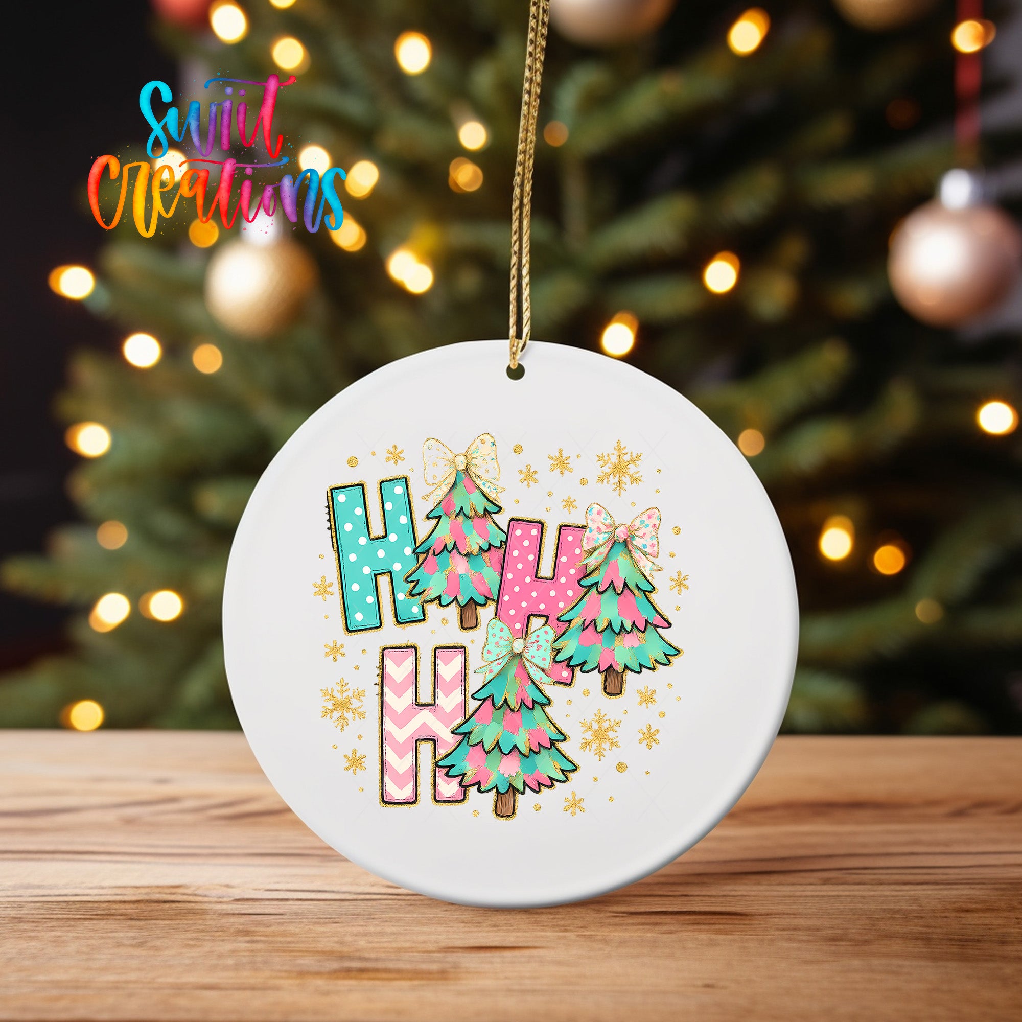 A white ceramic ornament with a colorful design featuring Christmas trees and snowflakes, hanging on a string.