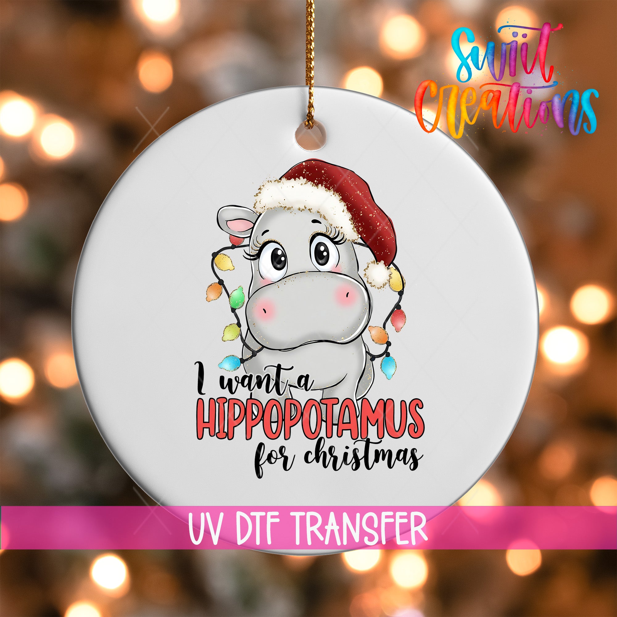 A white ornament with a cartoon image of a hippopotamus wearing a Santa hat and the text "I want a Hippopotamus for Christmas" printed on it.