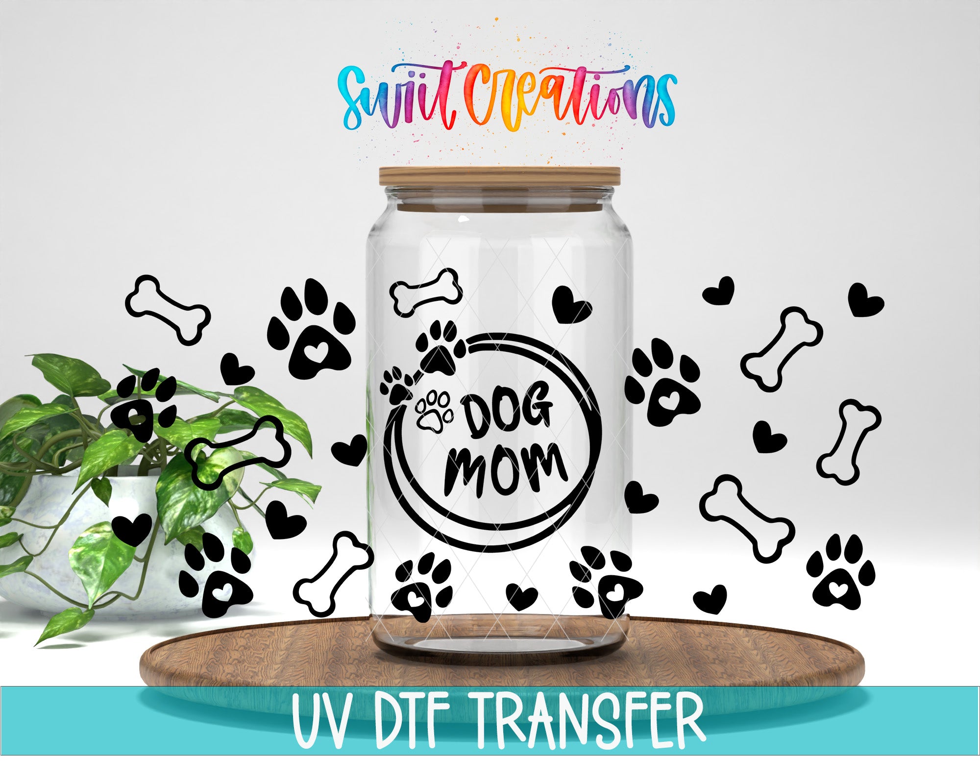 a clear glass jar with a lid, decorated with paw prints and dog bones, along with the text "Dog Mom" and "Swift Creations" written above it.