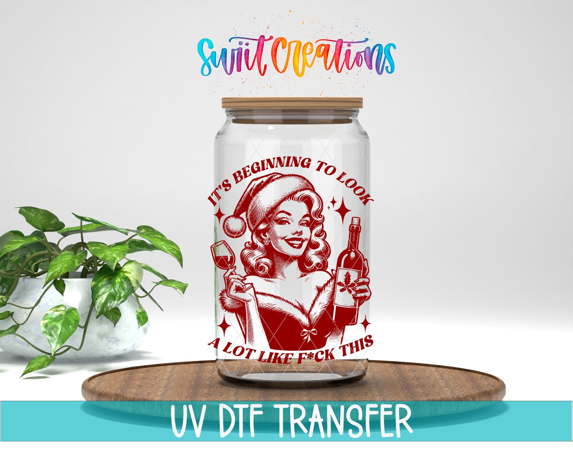 A glass jar with a red and white design featuring a woman holding a wine glass and a bottle, along with the text "It's Beginning to Look A Lot Like F*ck This" printed on it.