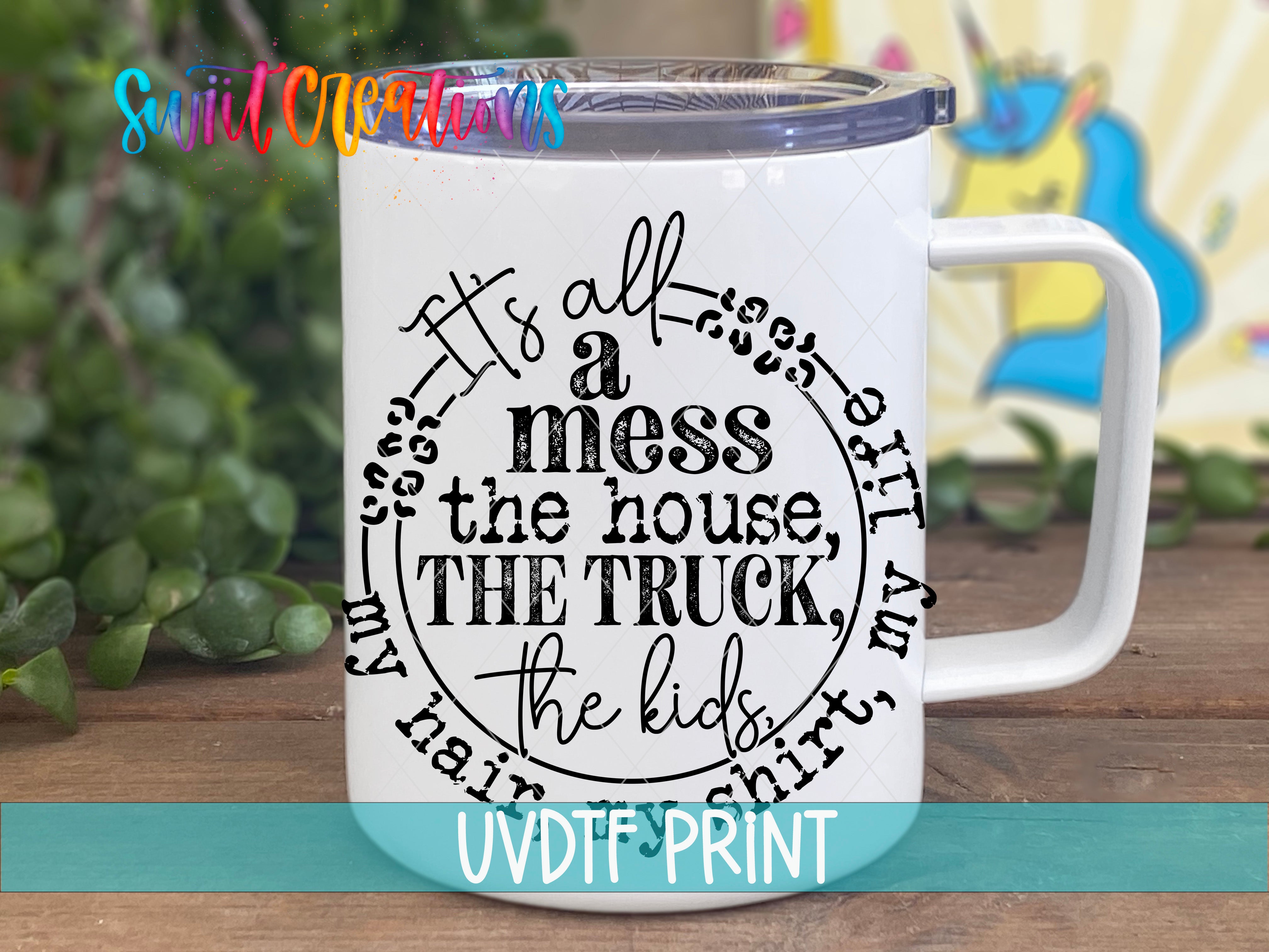 A white mug with a printed text design on it, placed on a wooden surface.