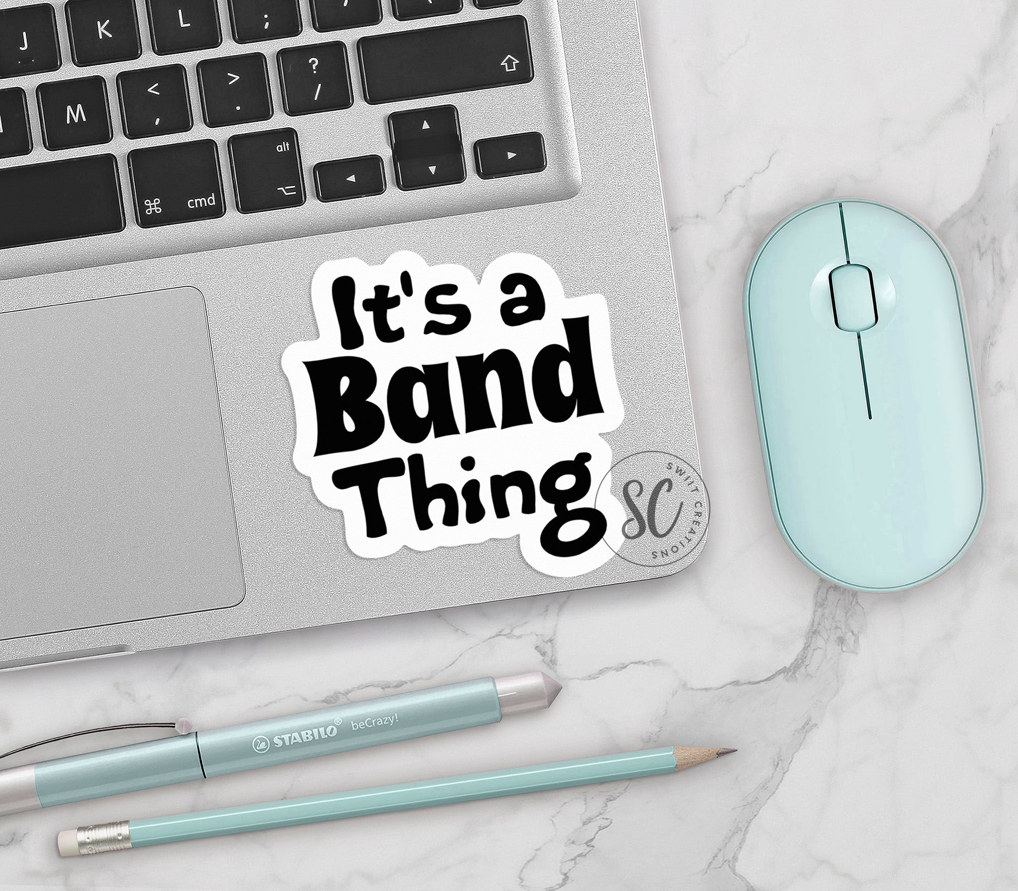 a sticker that says it's a band thing next to a mouse and