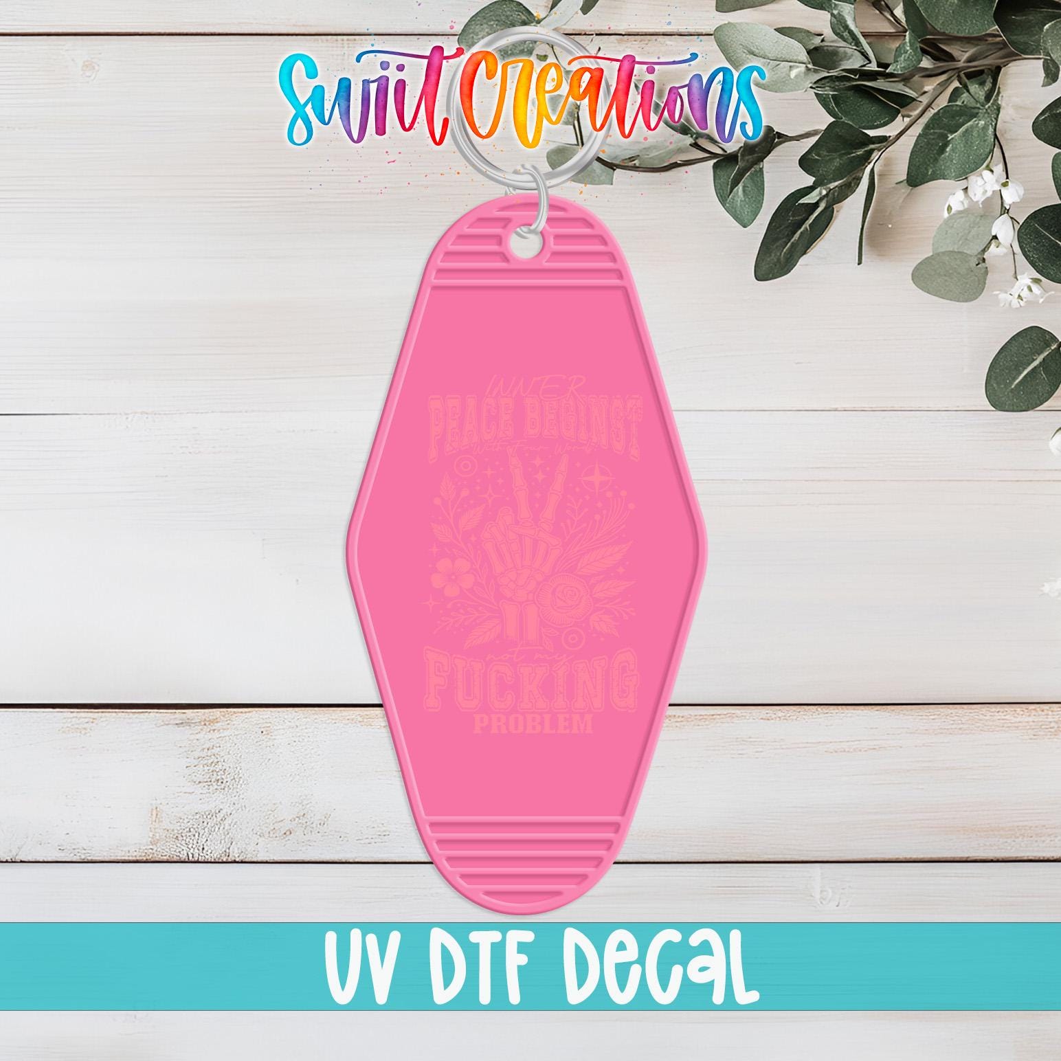 A pink keychain with the text "PRACE BUMBLE FUCKING PROBLEM" printed on it, along with a colorful logo and the text "Swit Creations" and "UV Dtf Decal" at the bottom.