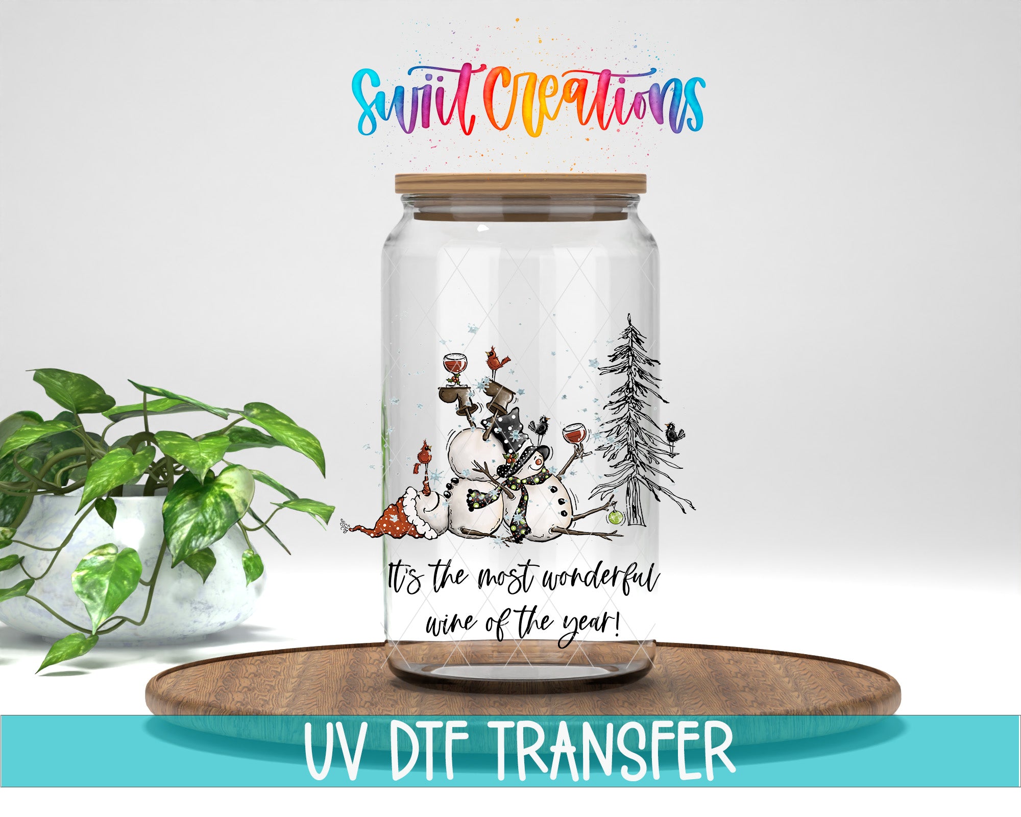 A glass jar with a snowman and Christmas tree illustration, placed on a wooden surface. The jar has a wooden lid and the text "It's the most wonderful wine of the year!" printed on it.