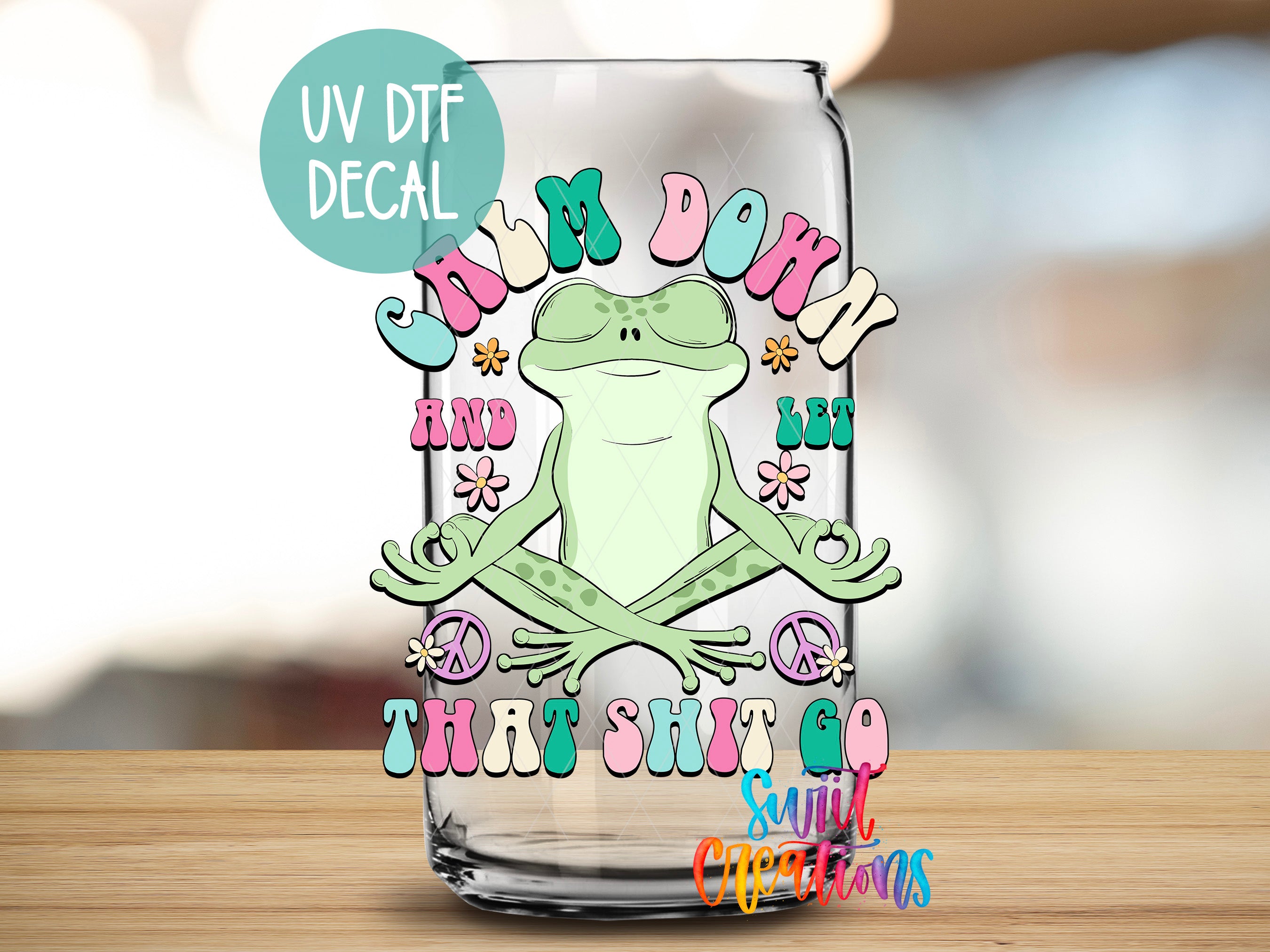 a glass with a frog sitting on top of it