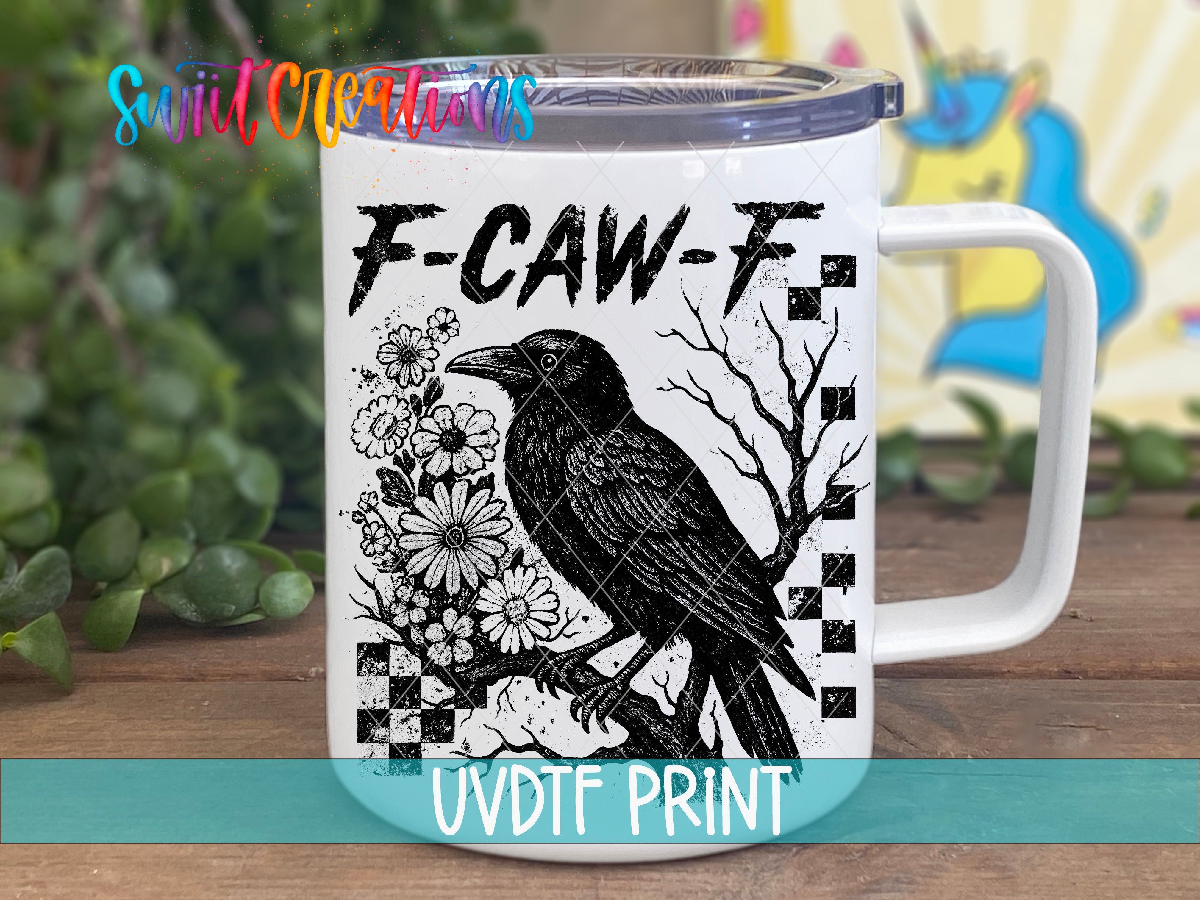 A white mug with a black and white illustration of a bird, flowers, and a checkered pattern on it.