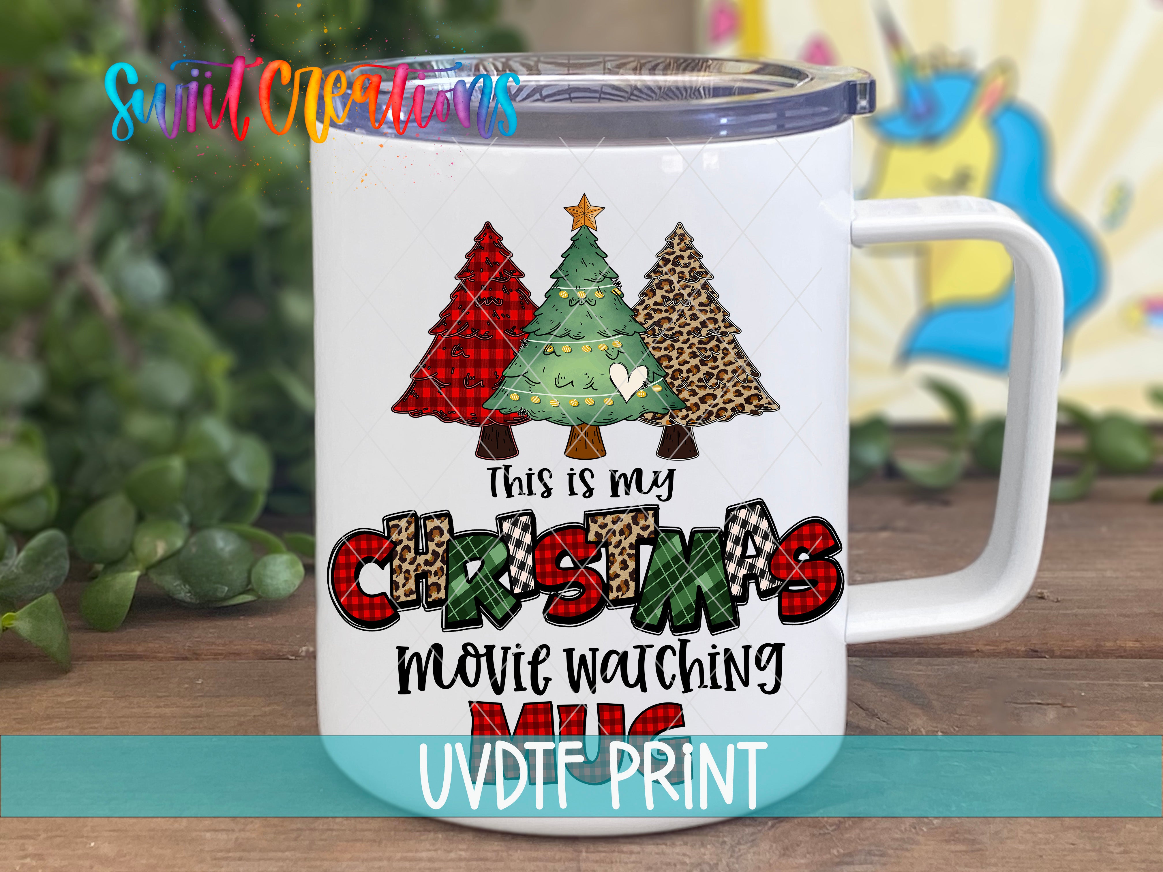 A white mug with a Christmas tree design and text printed on it.