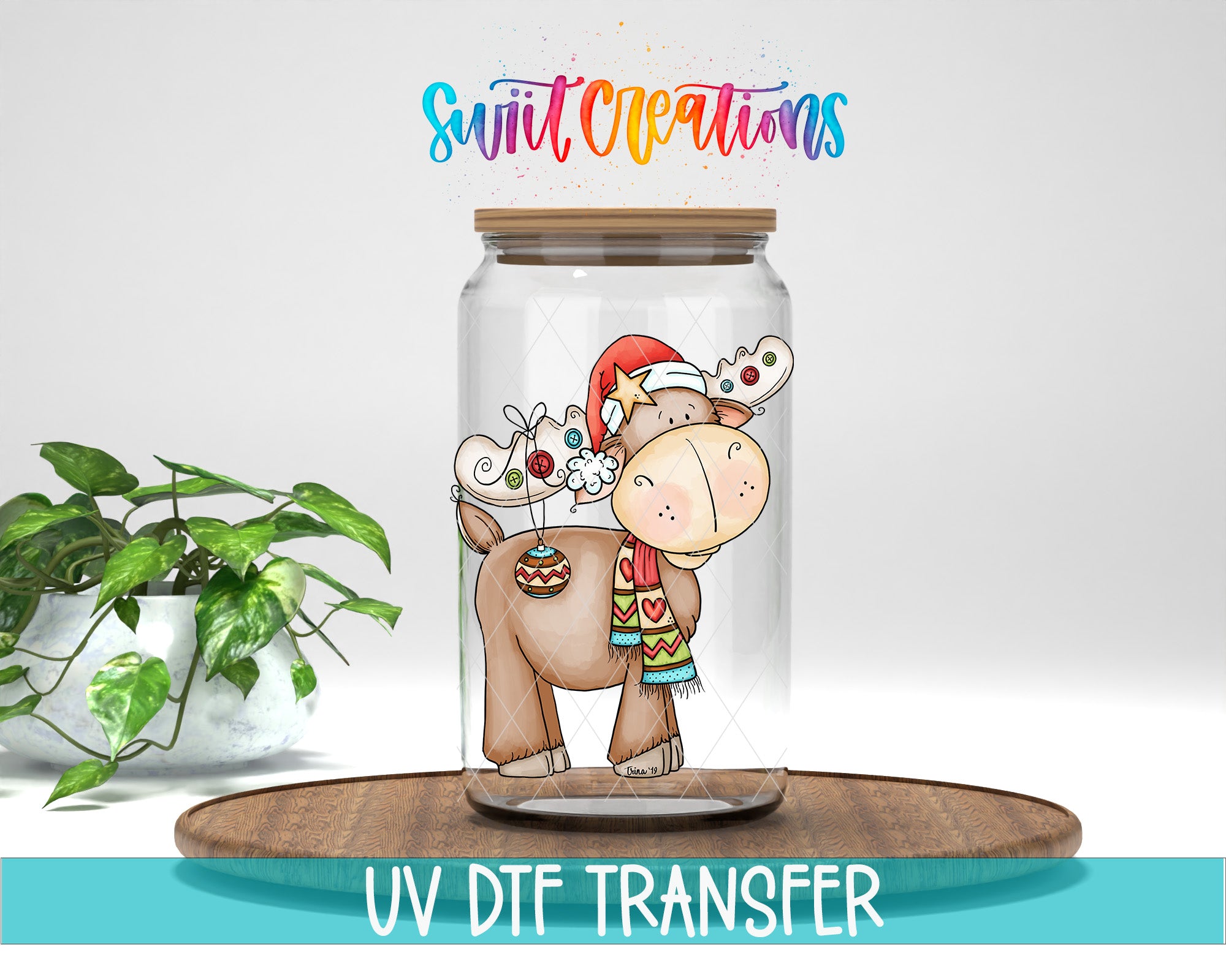 A glass jar containing a cartoon reindeer wearing a Santa hat and scarf, with the text "Swift Creations" written above it.