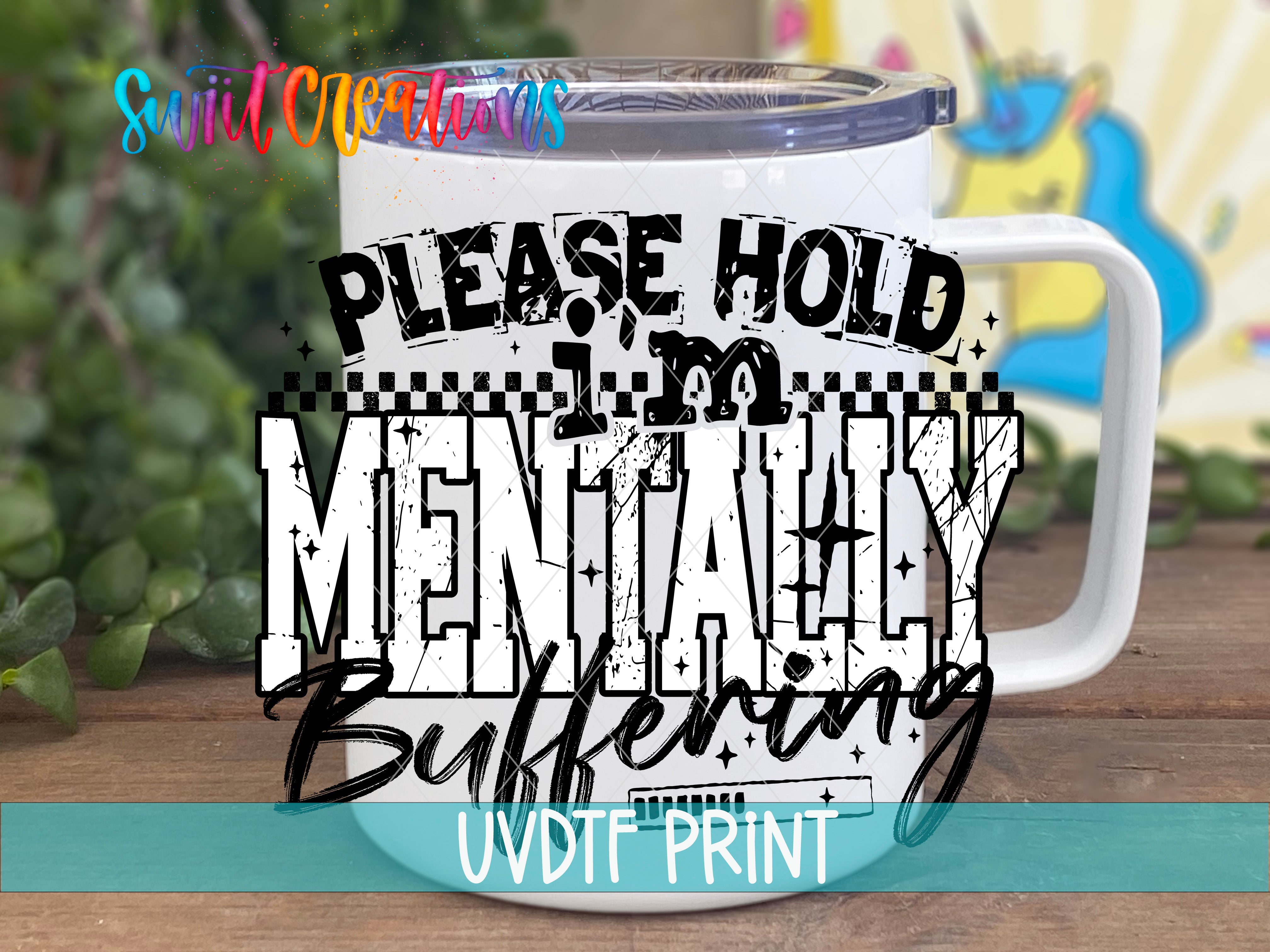a white mug with a humorous text printed on it, which reads "PLEASE HOLD MENTALLY Buffering" and is part of an advertisement for UVDIT print.