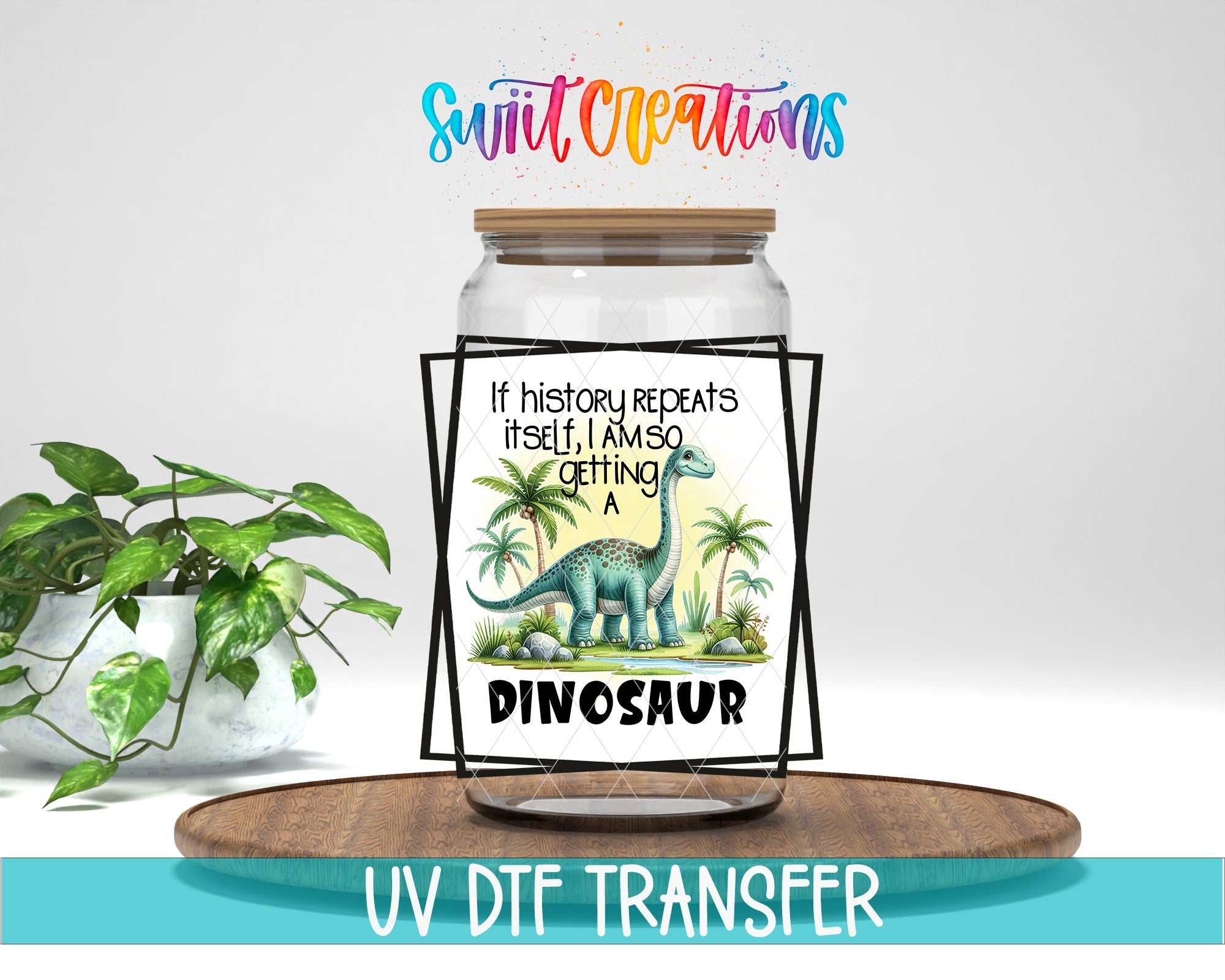 a dinosaur illustration on a jar with a wooden frame, placed on a wooden tray. The jar has a label that reads "If history repeats itself, I'm sure I'll get a dinosaur". The background of the image is white, and there is a plant visible on the left side.